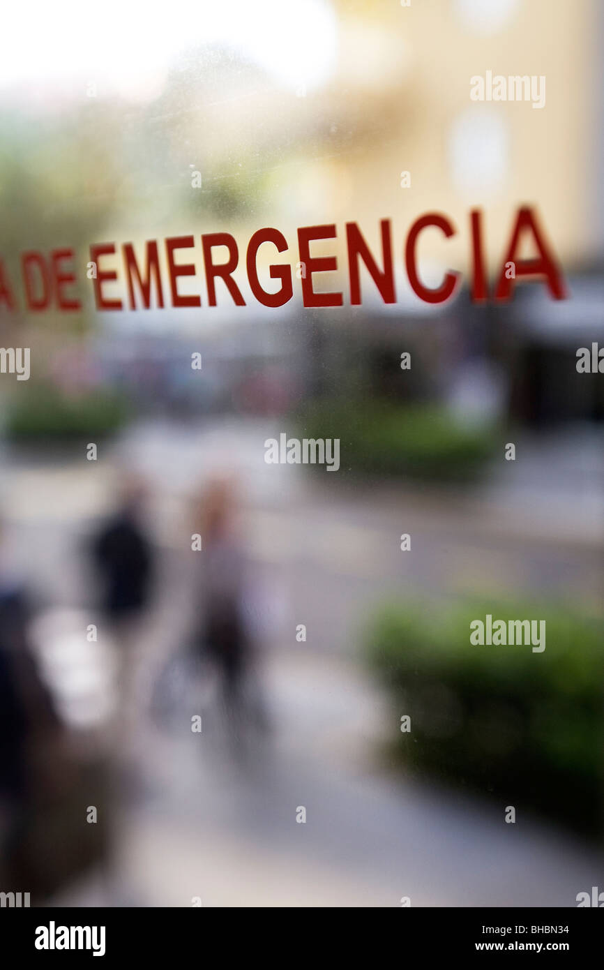 An emergency exit sign is clearly marked, in Spanish, on the window of a bus on the island of Tenerife. Stock Photo