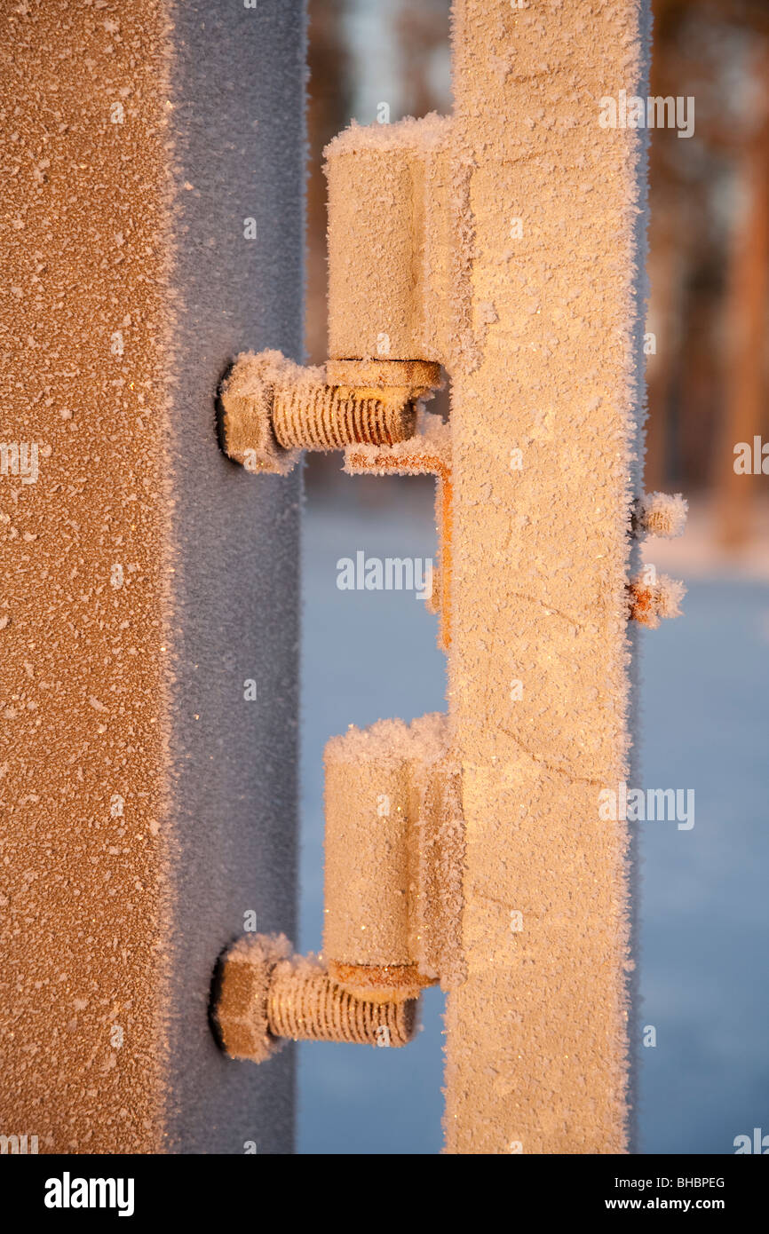 Frosty metal gate hinges Stock Photo