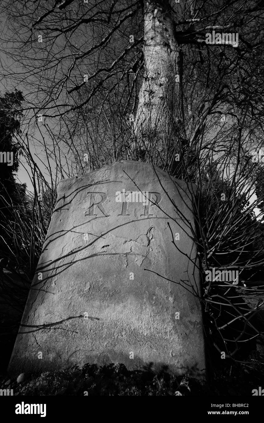 Gravestone old weathered with RIP digitally engraved inscription Stock Photo