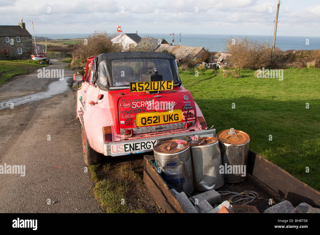 Pink ecological car made of various makers parts, running on Vegetable