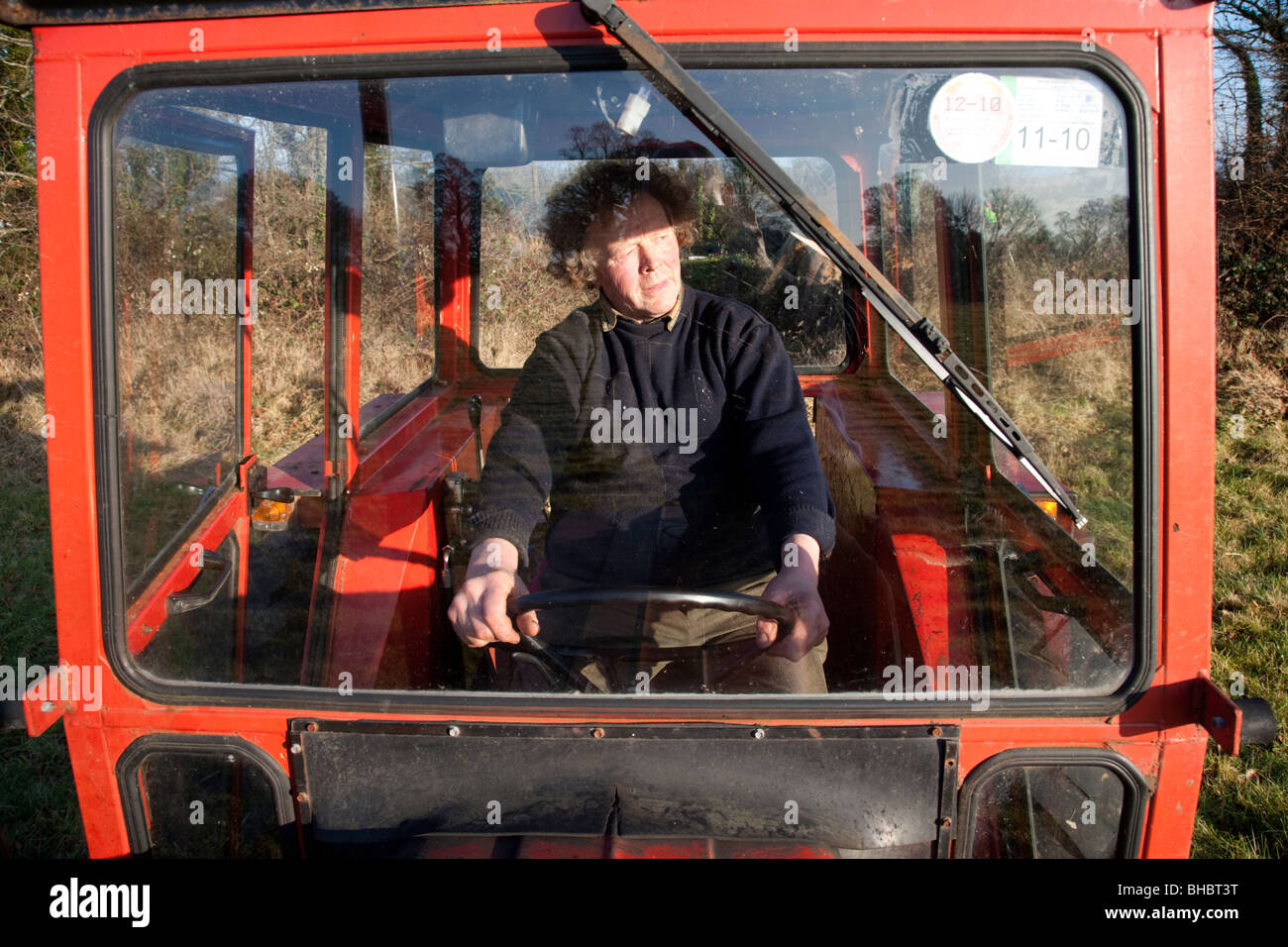 Irish farmer driving Massey Ferguson tractor Stock Photo Alamy