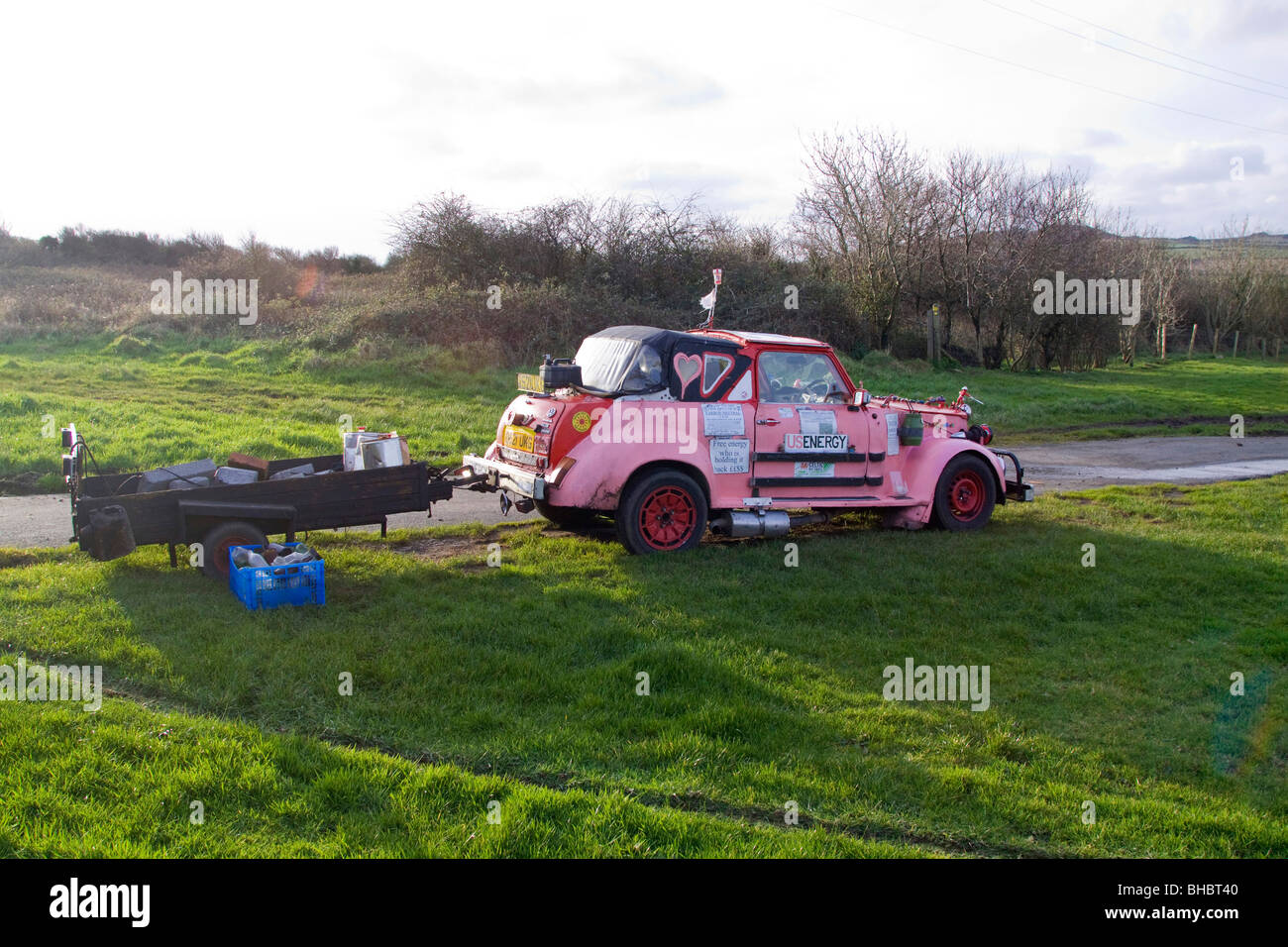 Pink ecological car made of various makers parts, running on Vegetable