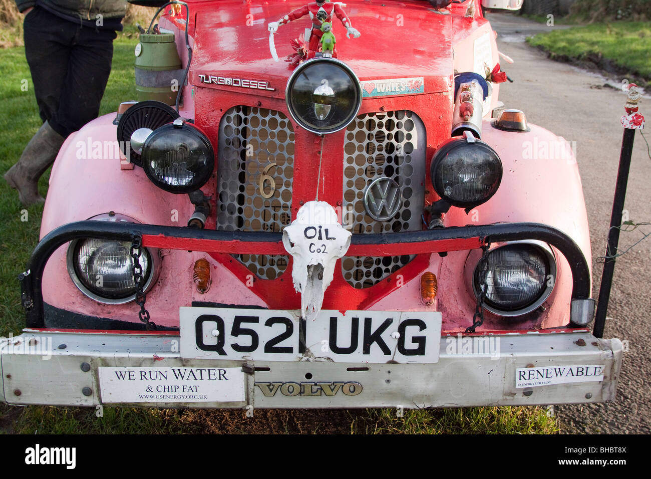 Pink ecological car made of various makers parts, running on Vegetable