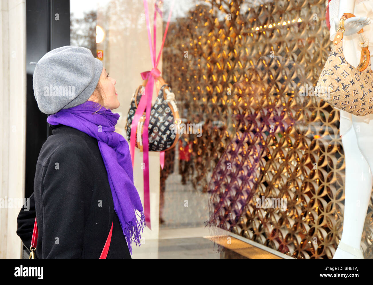 woman looking at fashion window in paris - Louis Vuitton Stock Photo