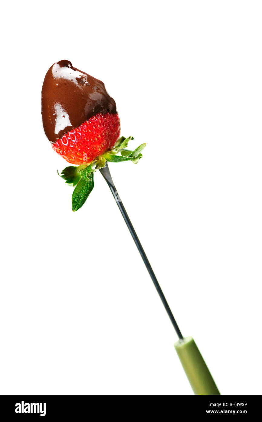Strawberry dipped in delicious chocolate on fondue skewer Stock Photo