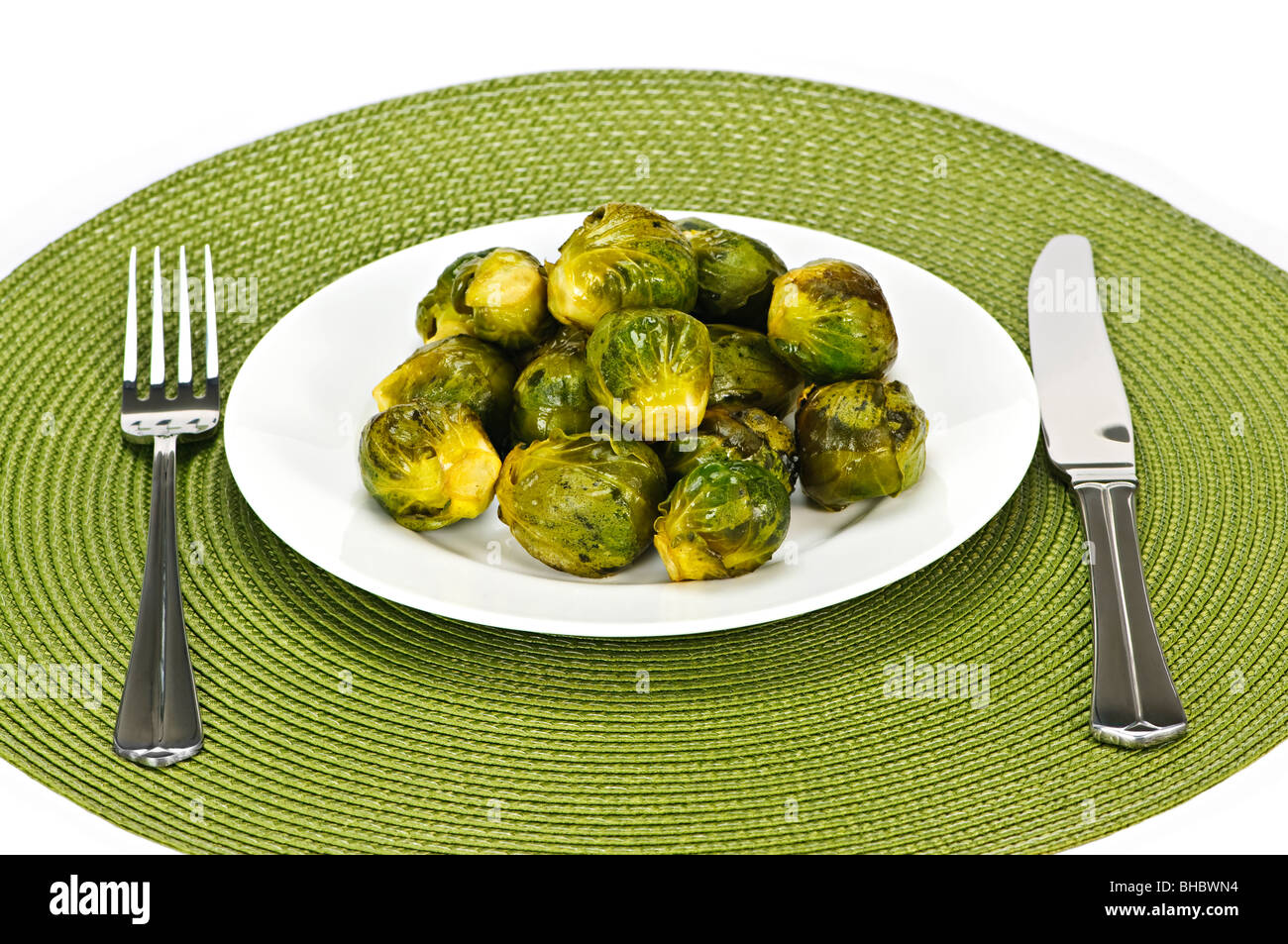 Plate of green brussels sprouts with knife and fork Stock Photo