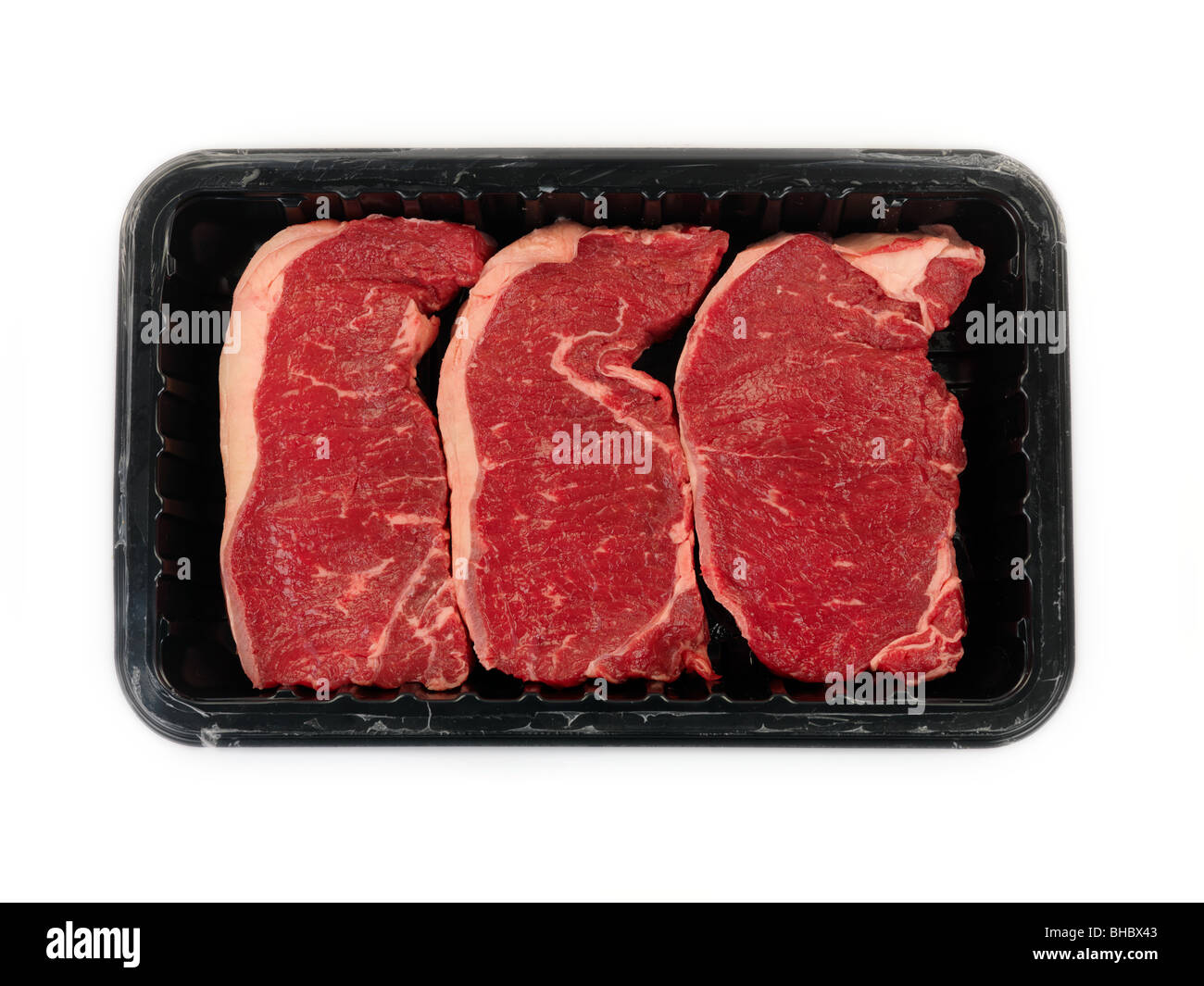 Supermarket packaged porterhouse steaks isolated against a white background Stock Photo