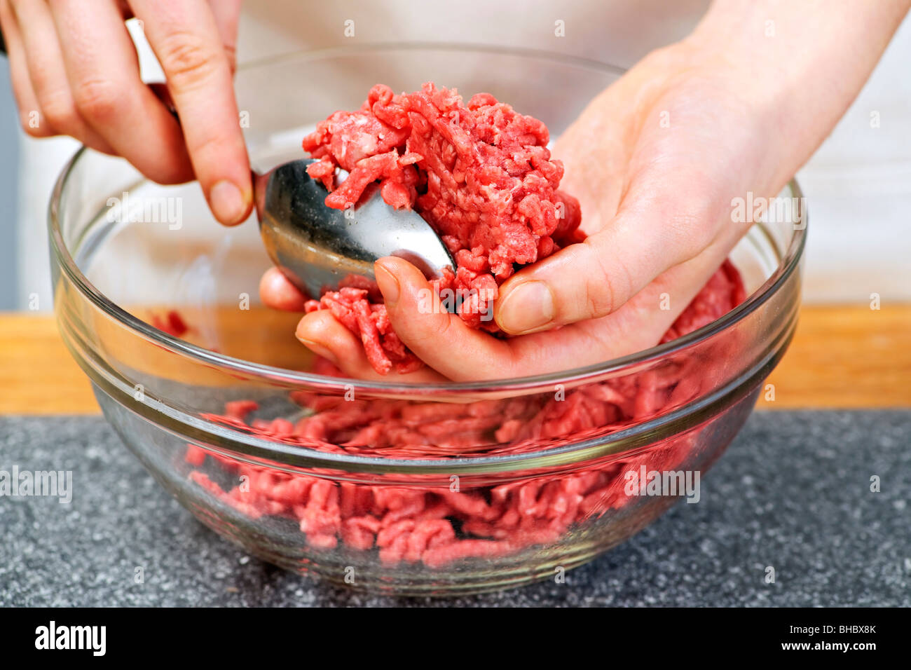 Chef making hamburgers in kitchen with ground beef Stock Photo - Alamy