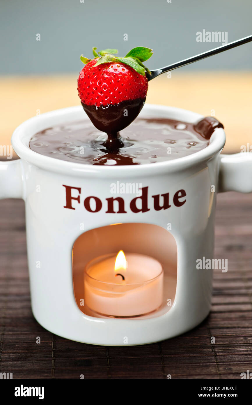 Strawberry dipped in delicious melted chocolate fondue Stock Photo