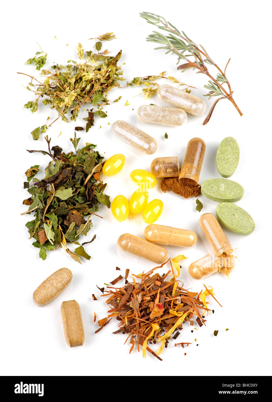 Herbs, herbal supplements and vitamin pills on white background Stock Photo