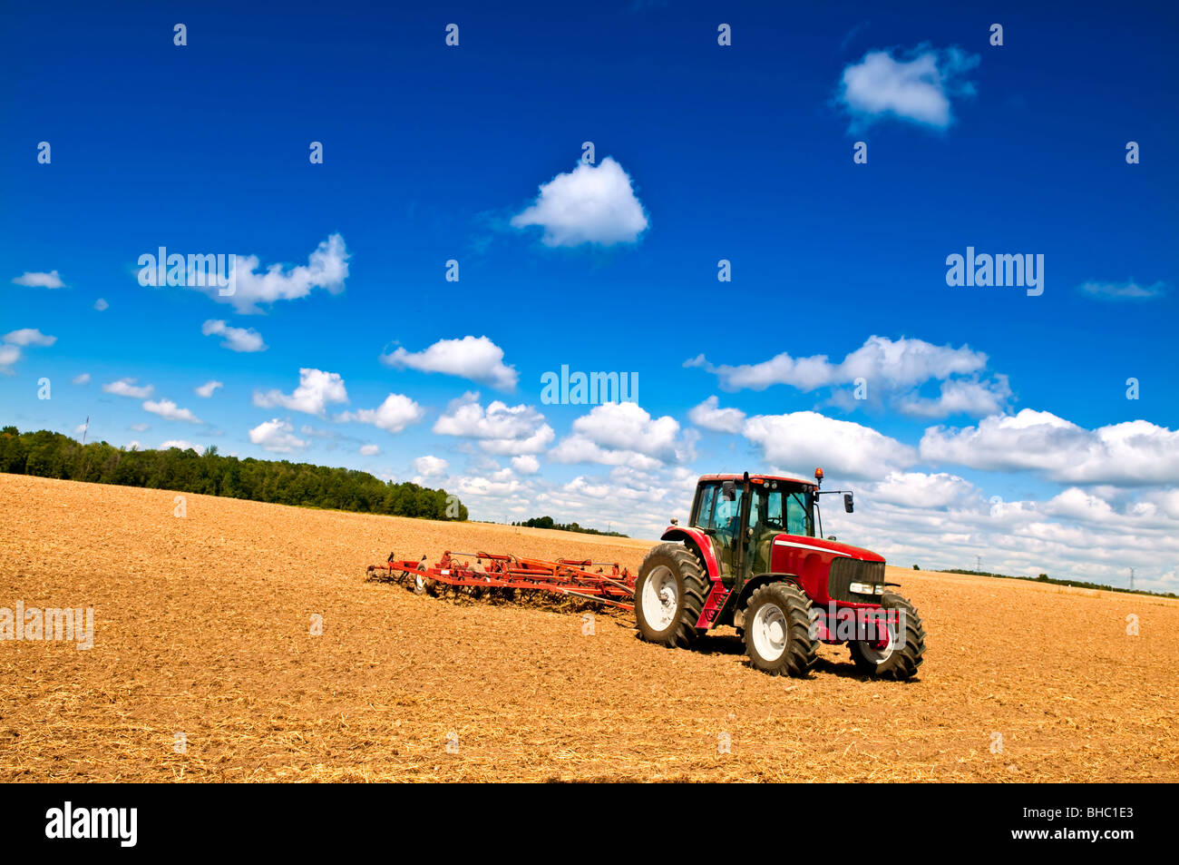 Small scale farming with tractor and plow in field Stock Photo Alamy