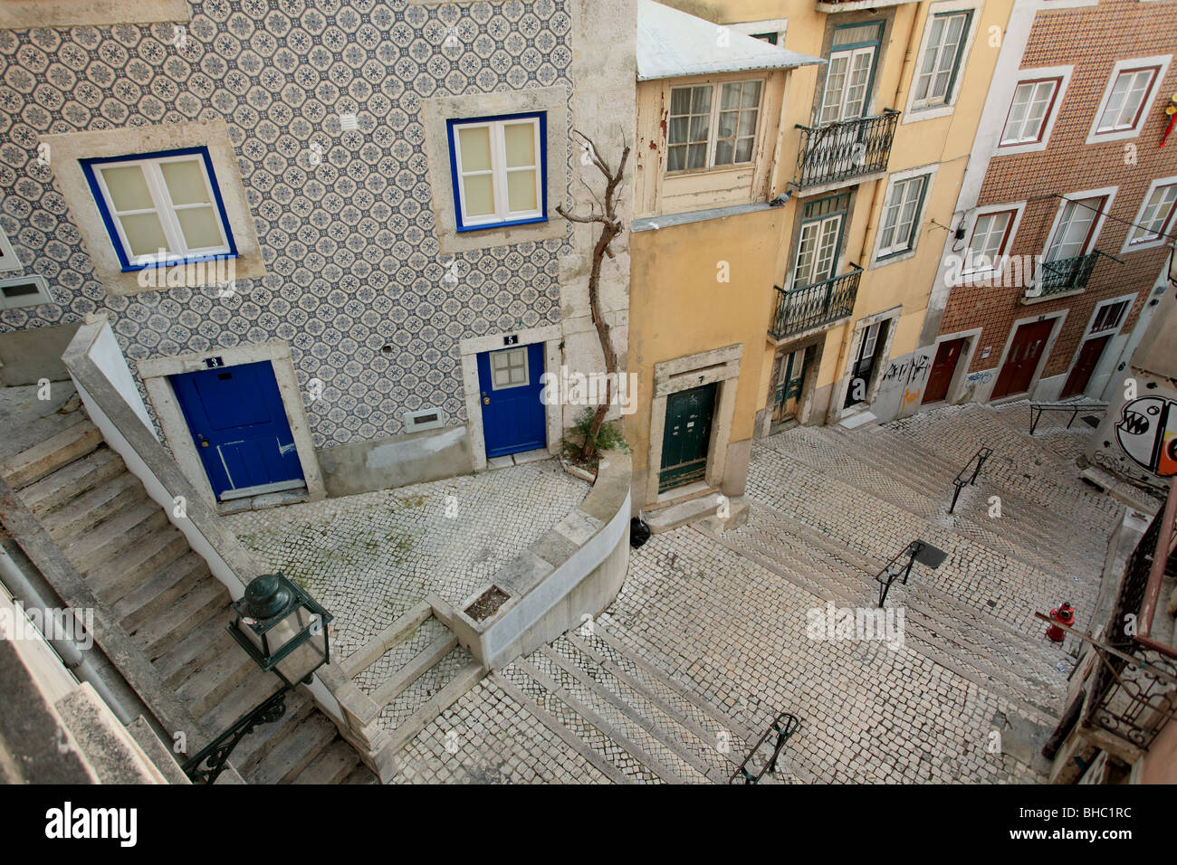 Traditional Lisbon housing with Azulejos tiles and paved street Stock Photo