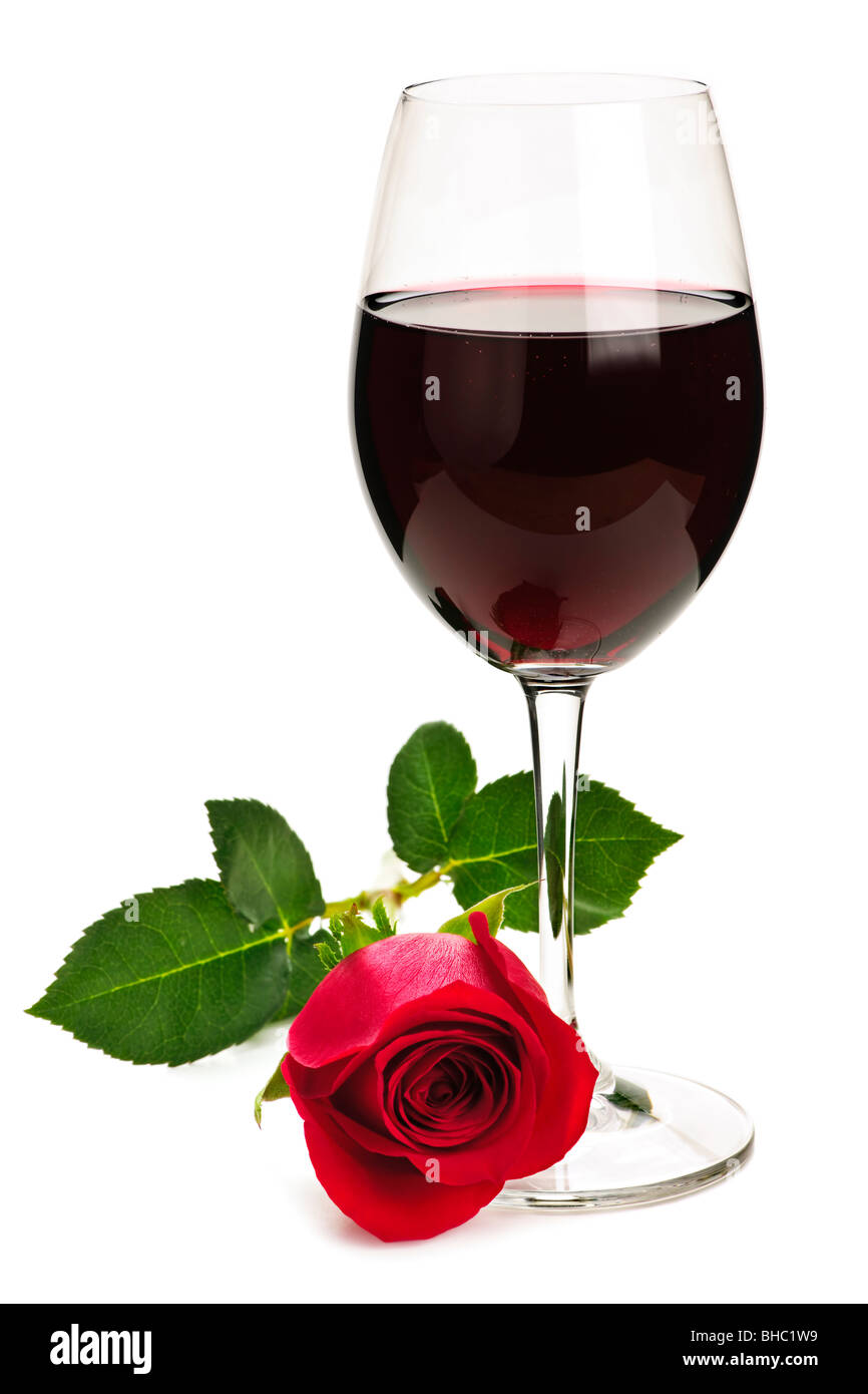 Romantic glass of red wine with long stemmed rose isolated on white ...