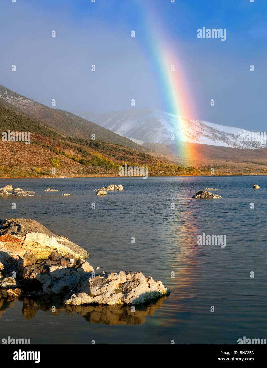 Rainbow with reflection and snow in mountains at Mono Lake. California