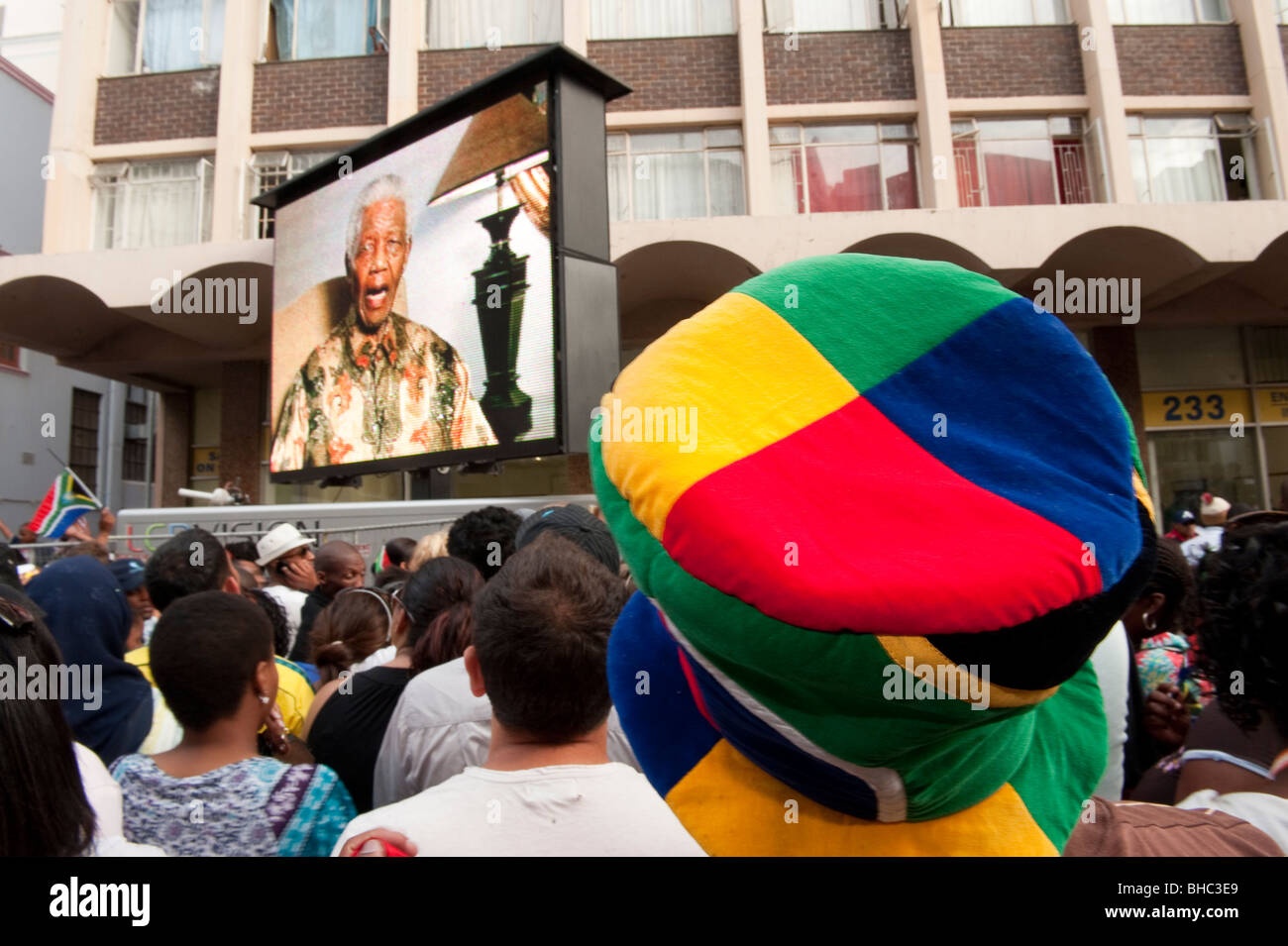 Public viewing football fan watching Nelson Mandela on a screen FIFA Fan Mile in Cape Town South Africa Stock Photo
