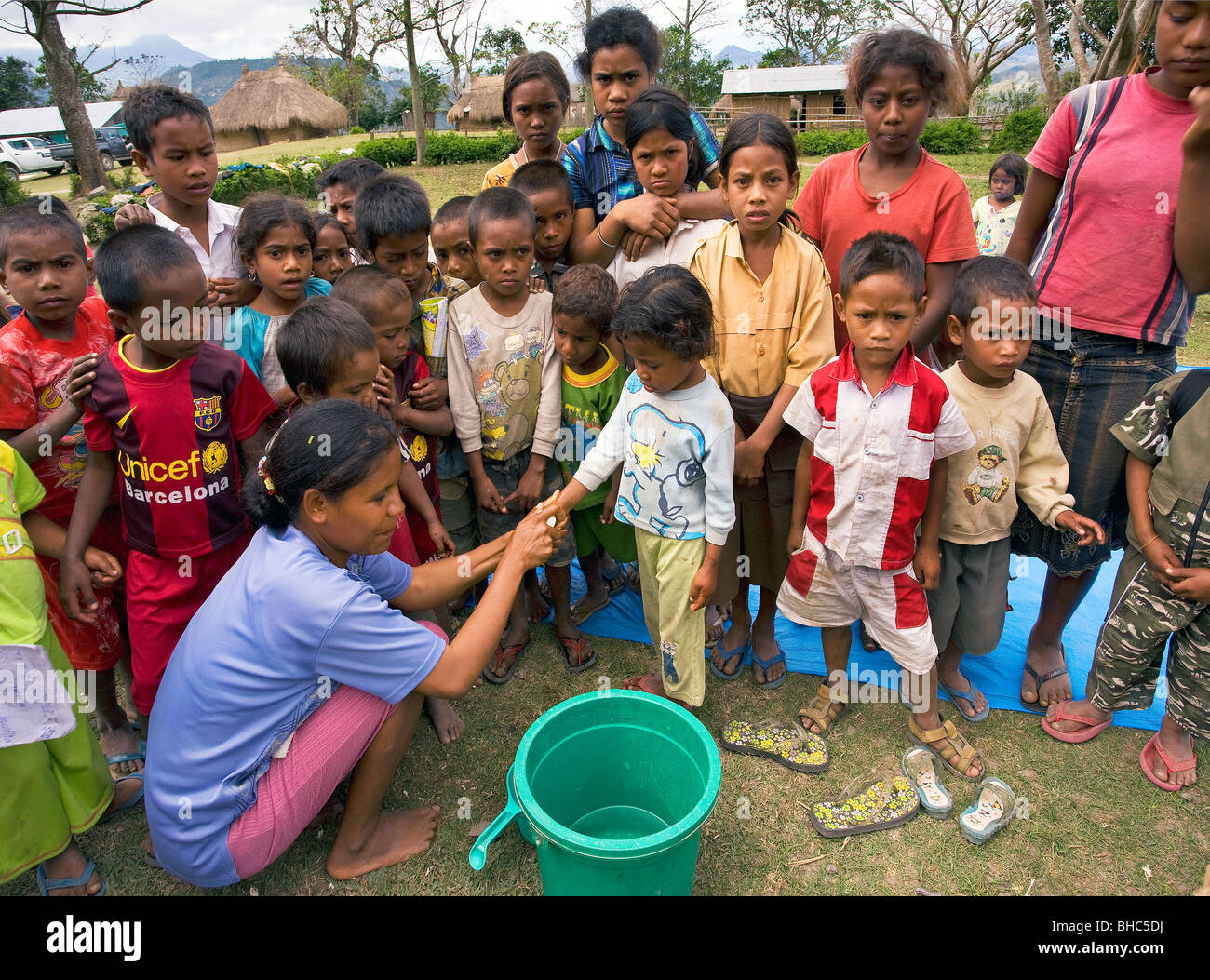 Brigitte Madeira of Oxfam-Covalima teaches children hygiene at remote impoverished mountain village Welua in East Timor Stock Photo