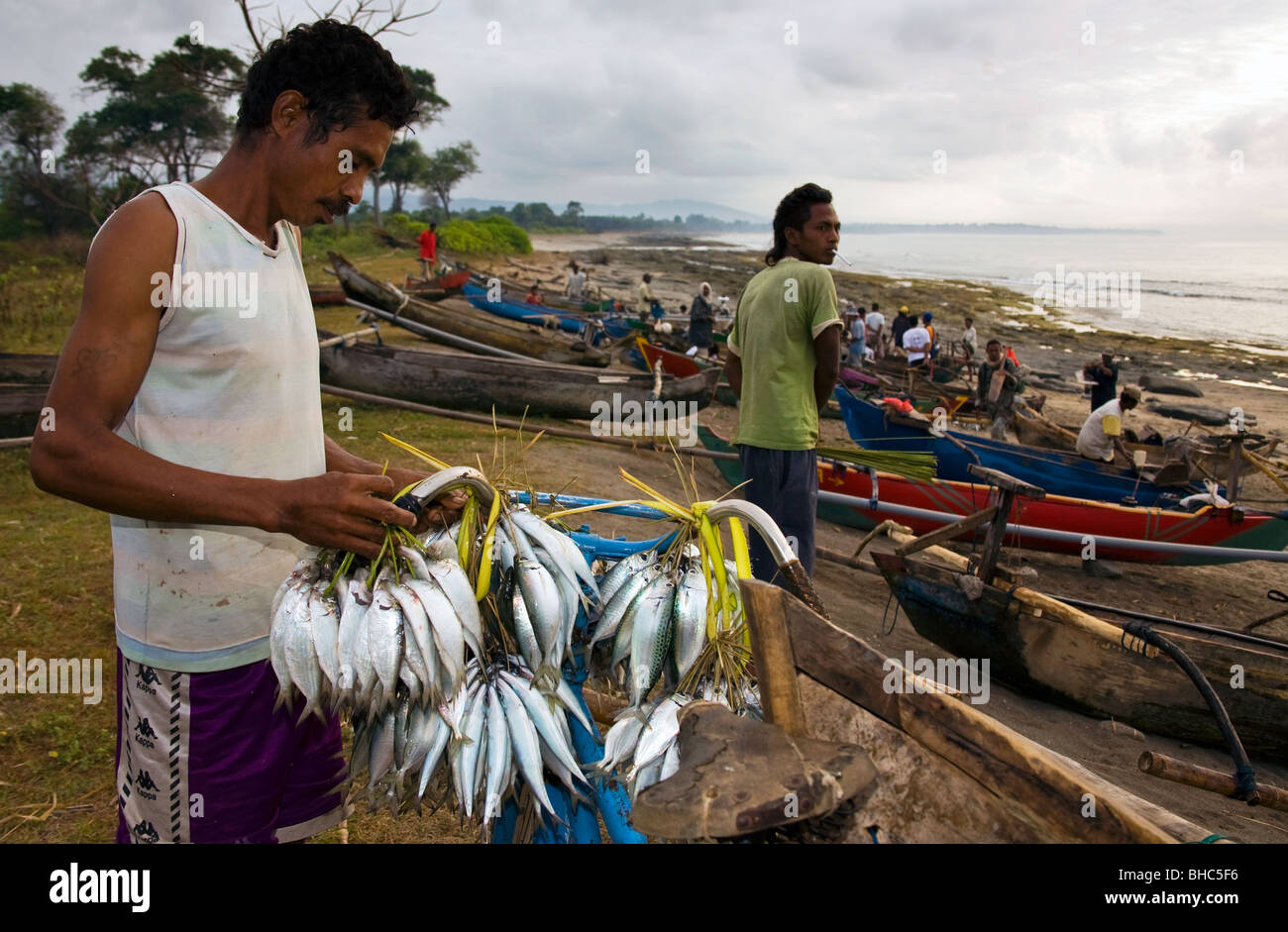 young man with fresh fish for sale at Suai-Loro at dawn East Timor , Oxfam supplied fishermen with nets and equipment Stock Photo