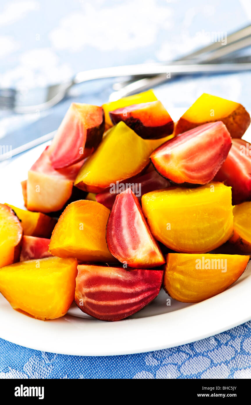 Roasted sliced red and golden beets on a plate Stock Photo