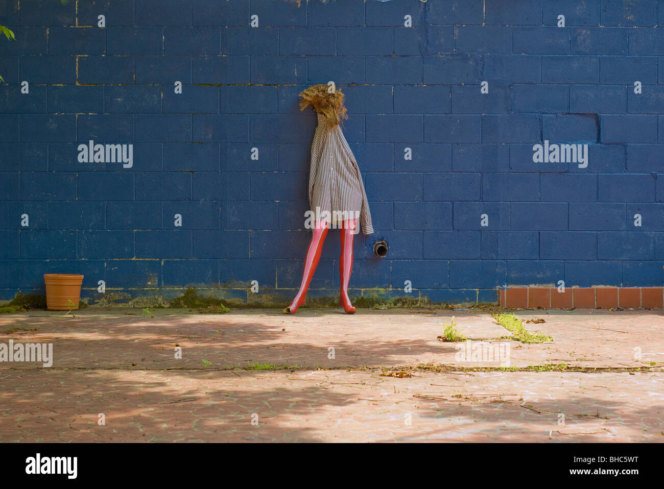 The bottom half of a mannequin is dressed and leans against a wall in New Orleans, LA Stock