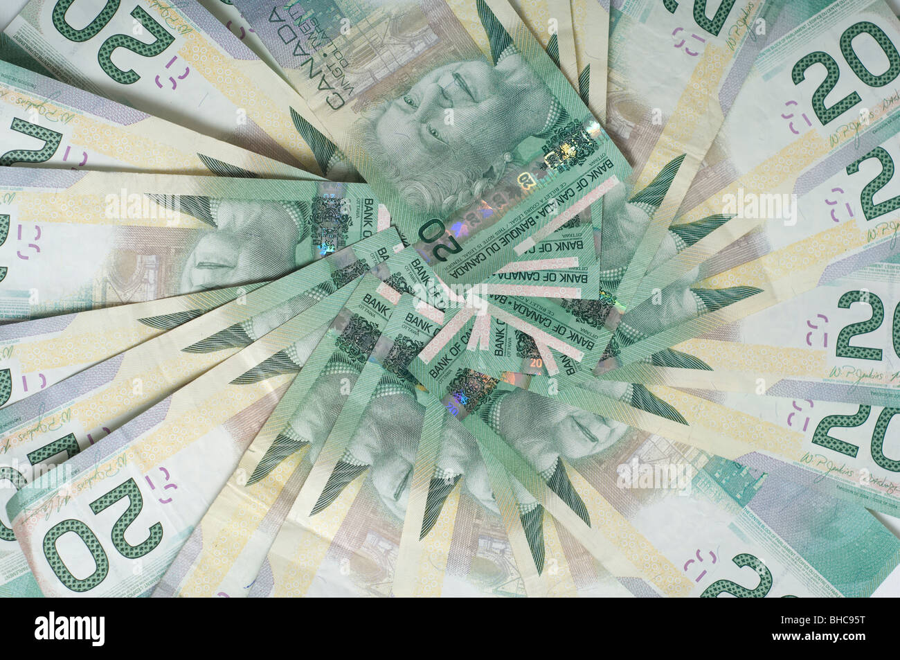 A large amount of Canadian 20 dollar bills arranged in a circle, filling the frame Stock Photo