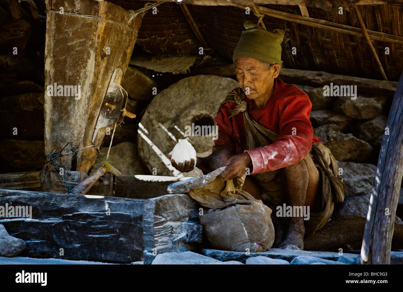 A NEPALI MAN grinds wheat into FLOUR using a stone water wheel AROUND