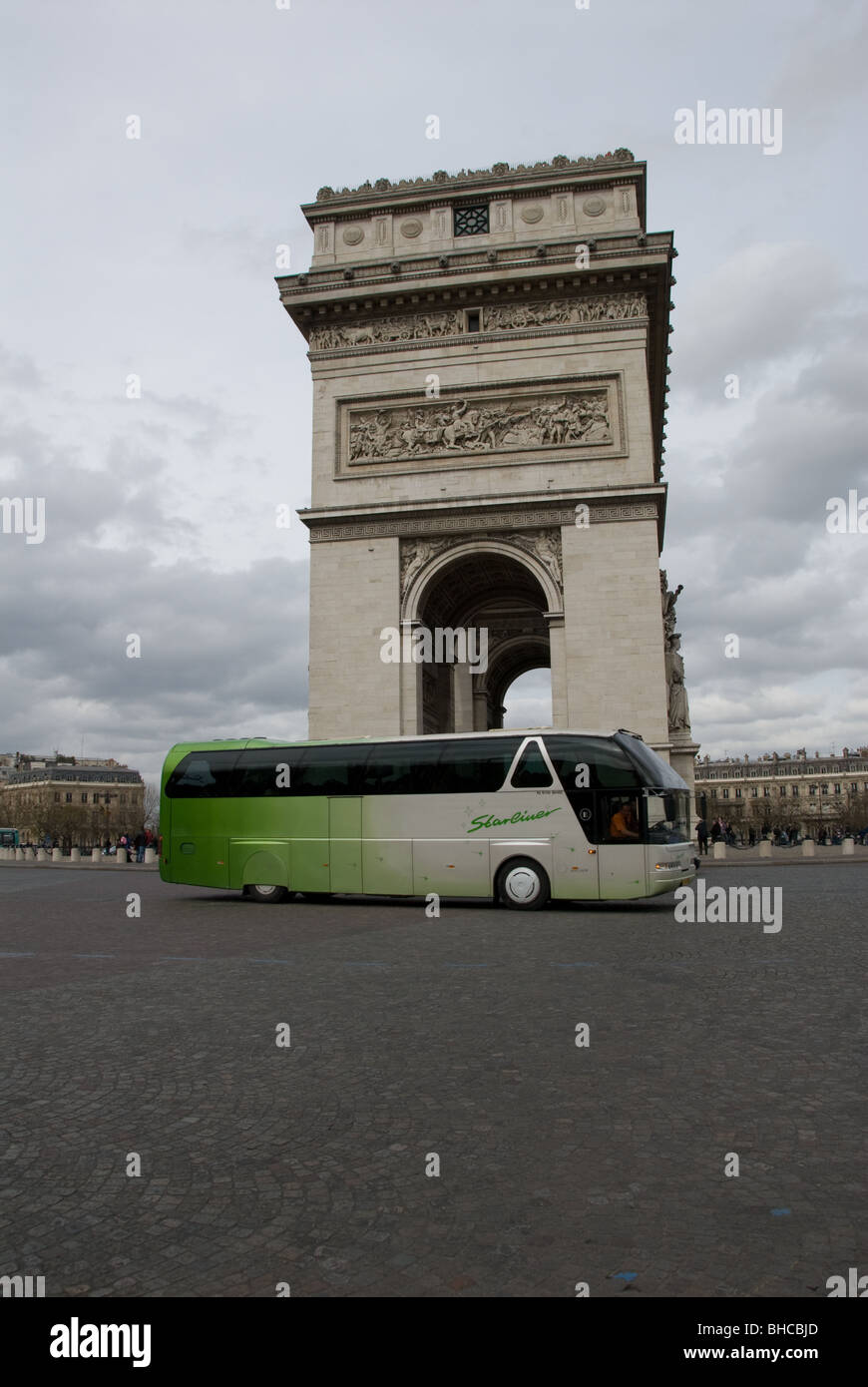 A Neoplan Starliner coach drives around the Place de l'Etoile passing the Arc de Triomphe in Paris, France Stock Photo