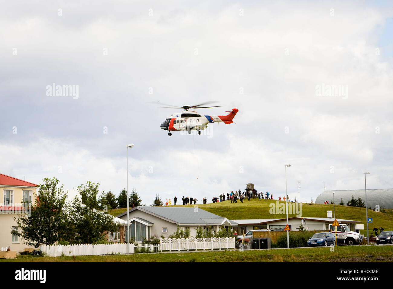 Helicopter from The Icelandic Coast Guard flies over Vogar in Vatnsleysustrond, Iceland. Stock Photo