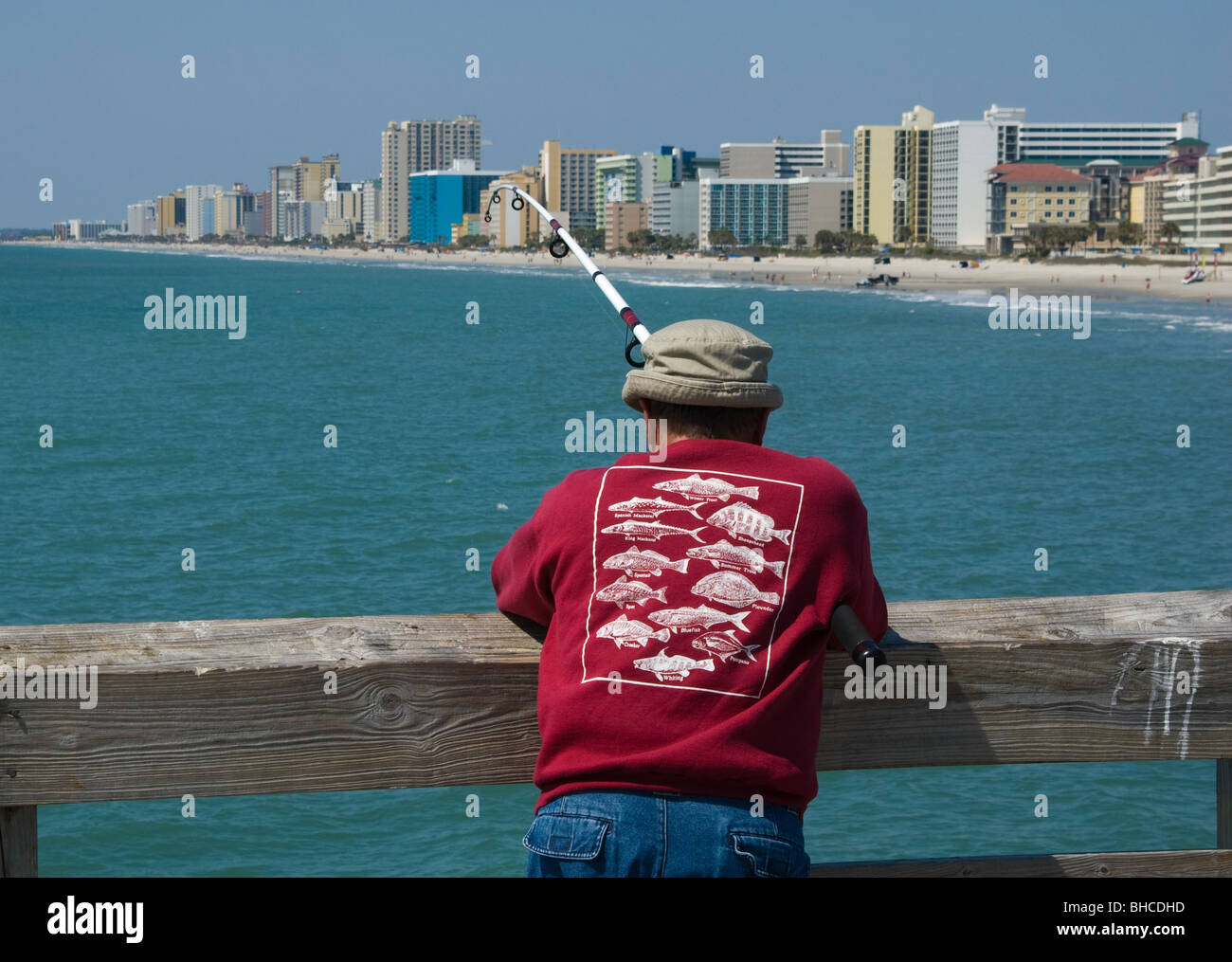 Man fishing from a pier in Myrtle Beach, South Carolina, USA Stock Photo