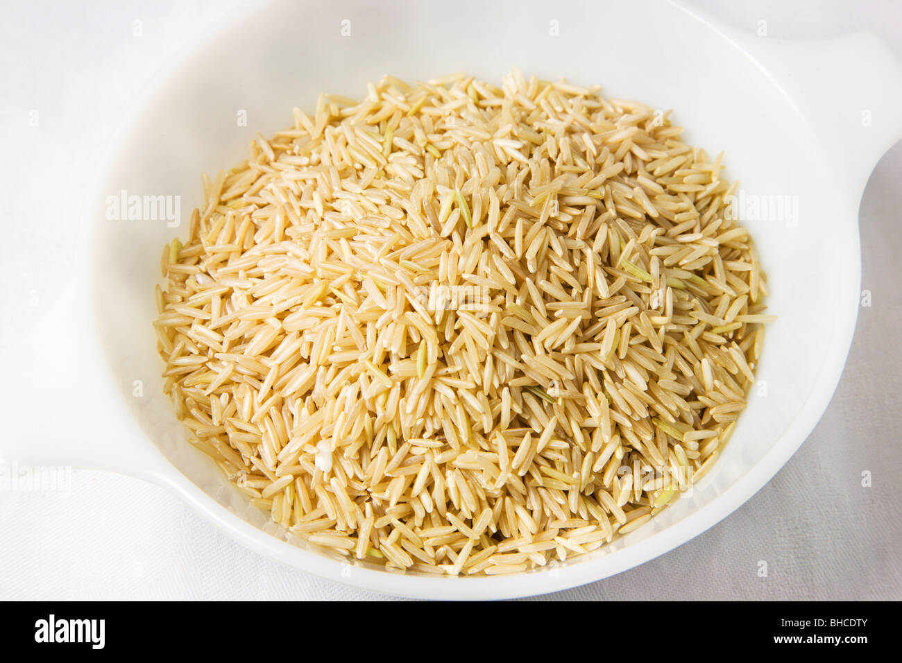 Fair Trade Organic Brown Basmati Rice in a White Dish Stock Photo