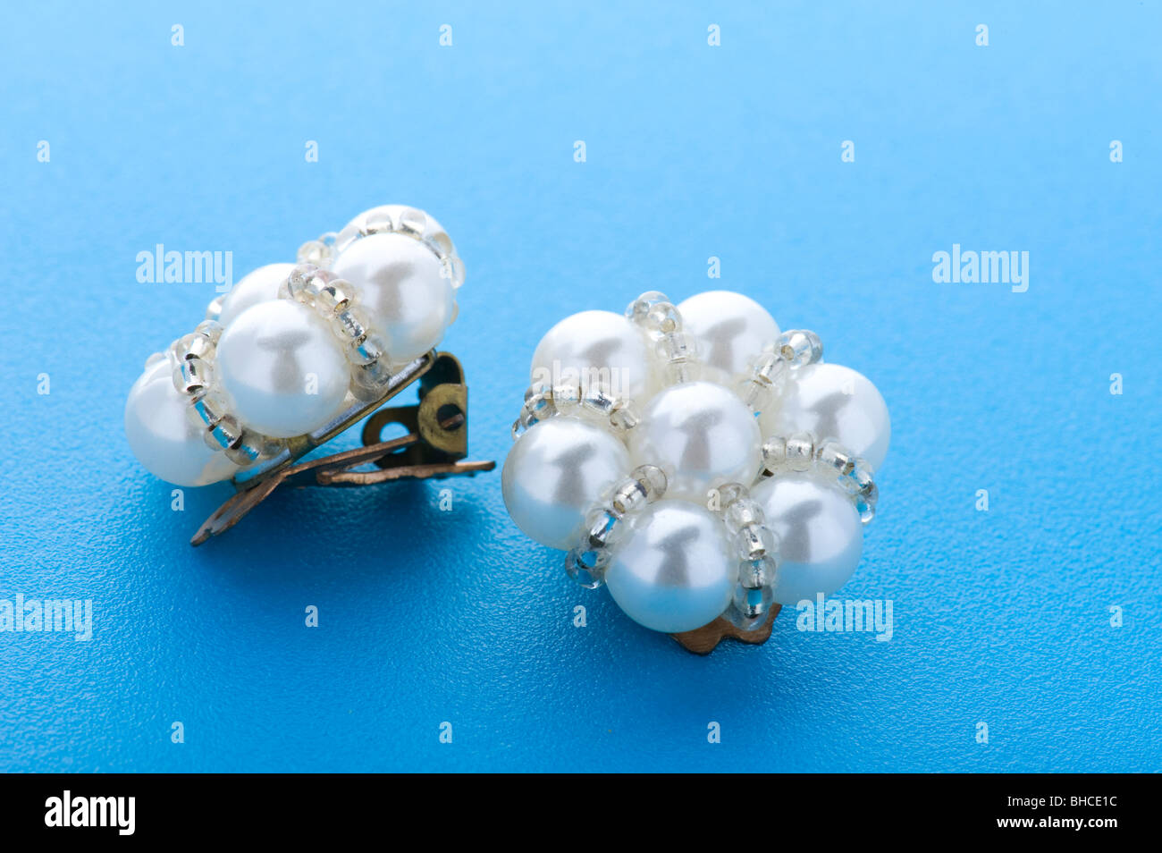 object on blue - costume jewellery earring close up Stock Photo