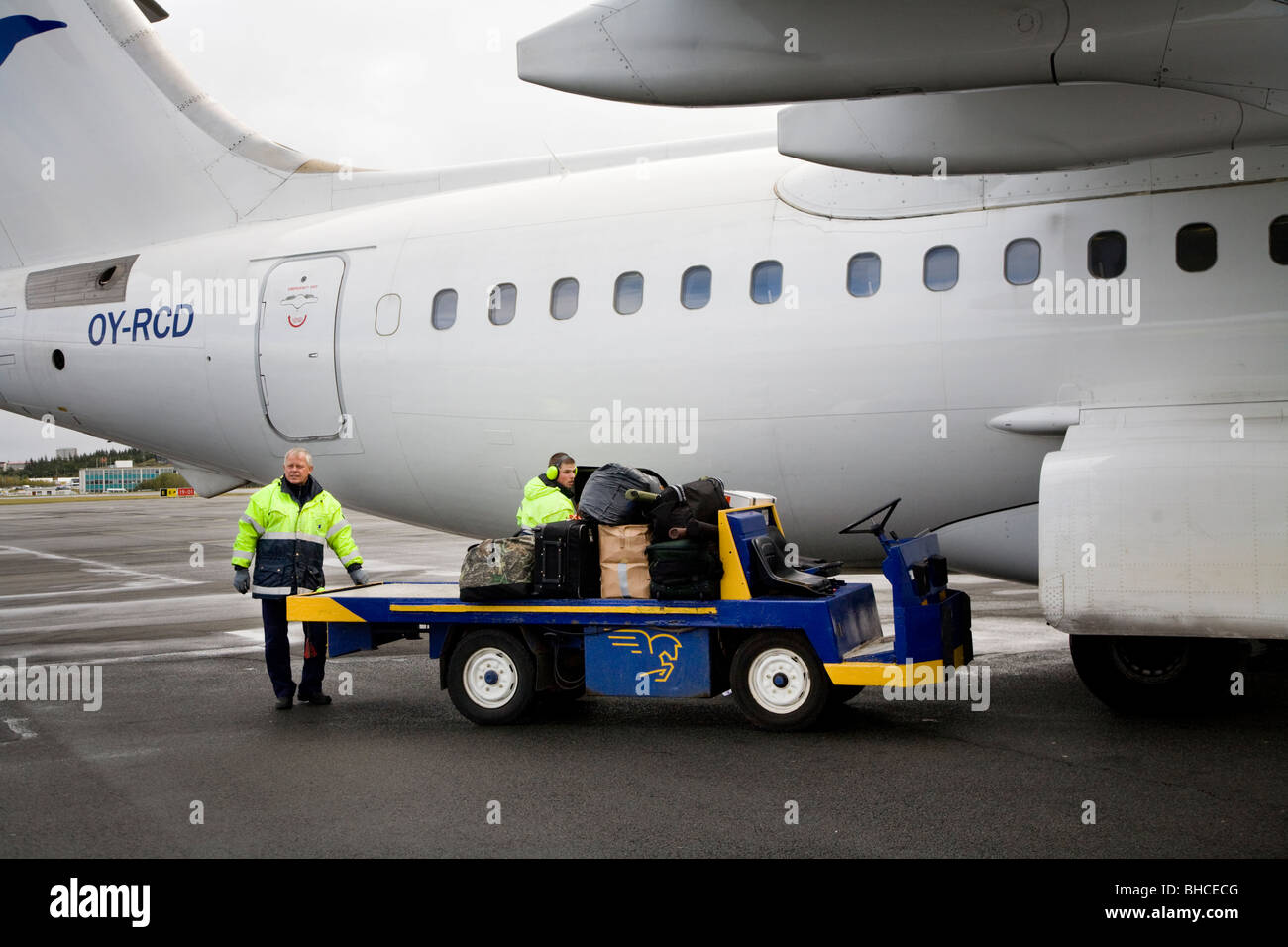 Workers unloading luggage at Reykjavik airport, Iceland. Stock Photo