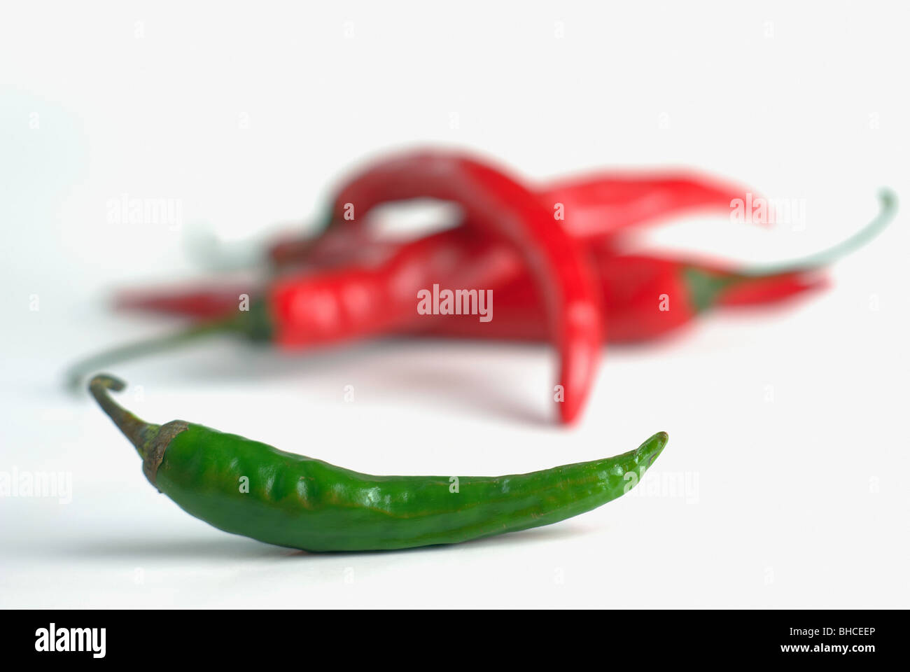 red and green hot chili pepper on a white background Stock Photo - Alamy