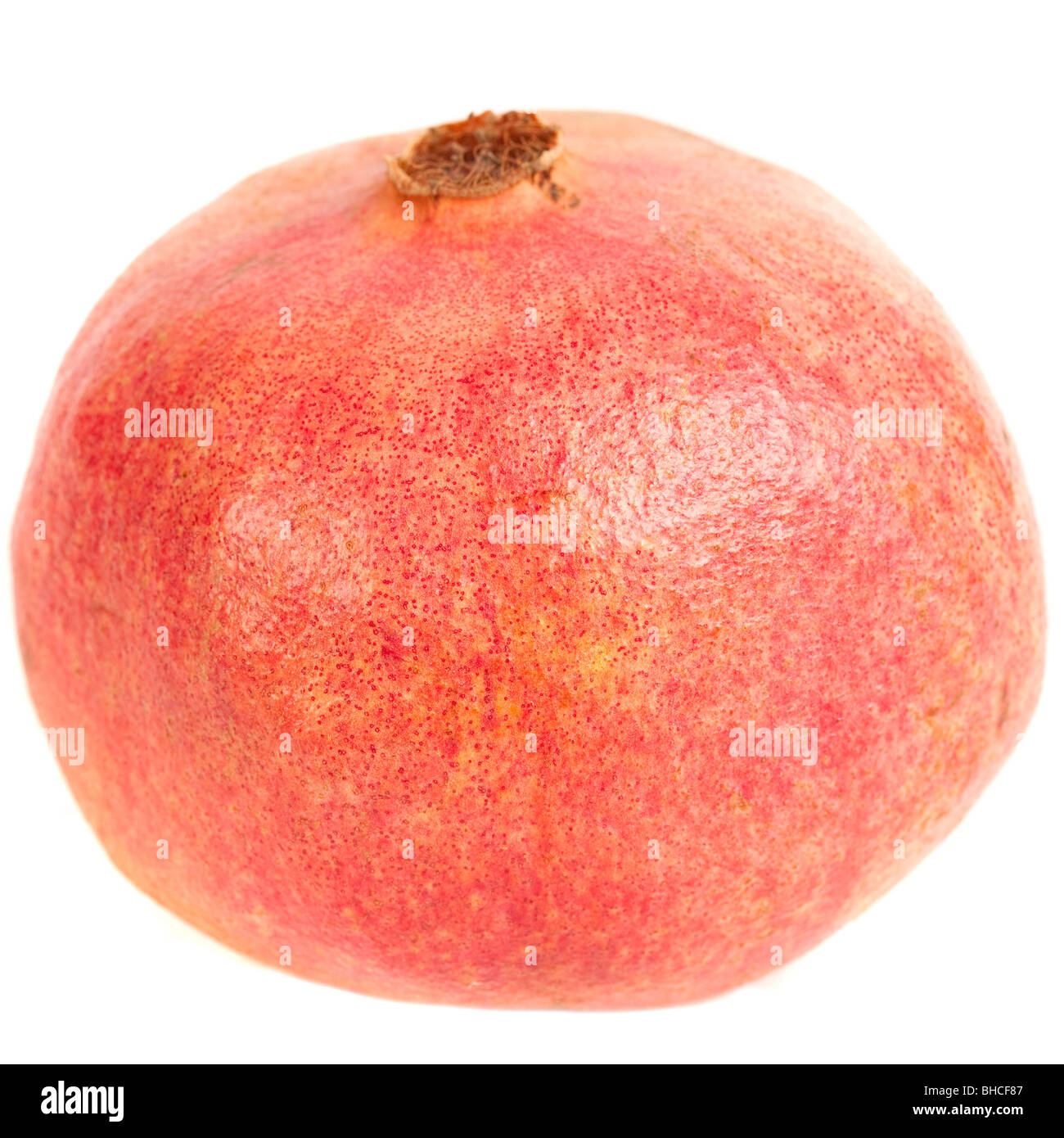 Close up of a whole pomegranate fruit, isolated on white background Stock Photo