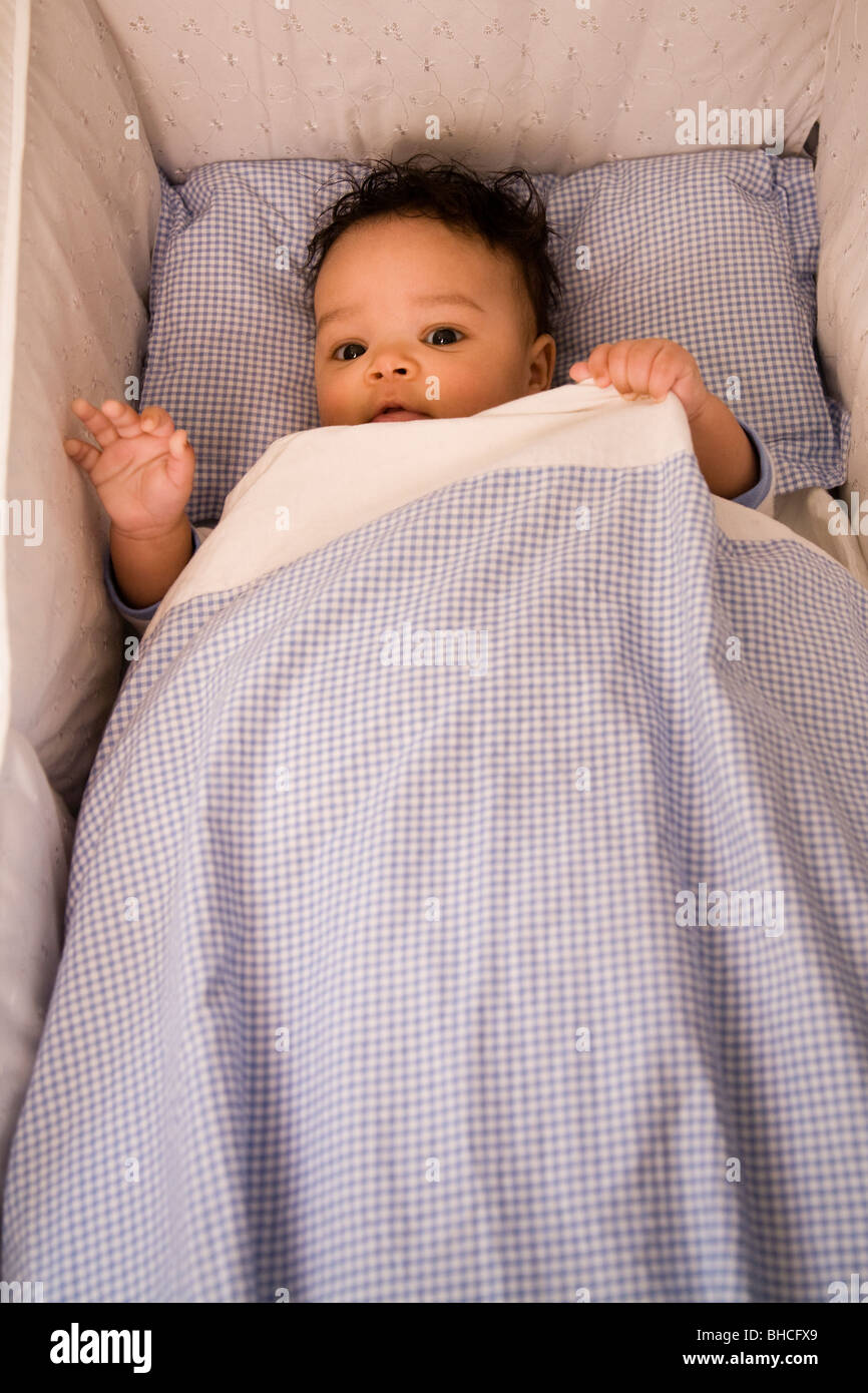 3 1/2 months boy lying in his bed. Stock Photo