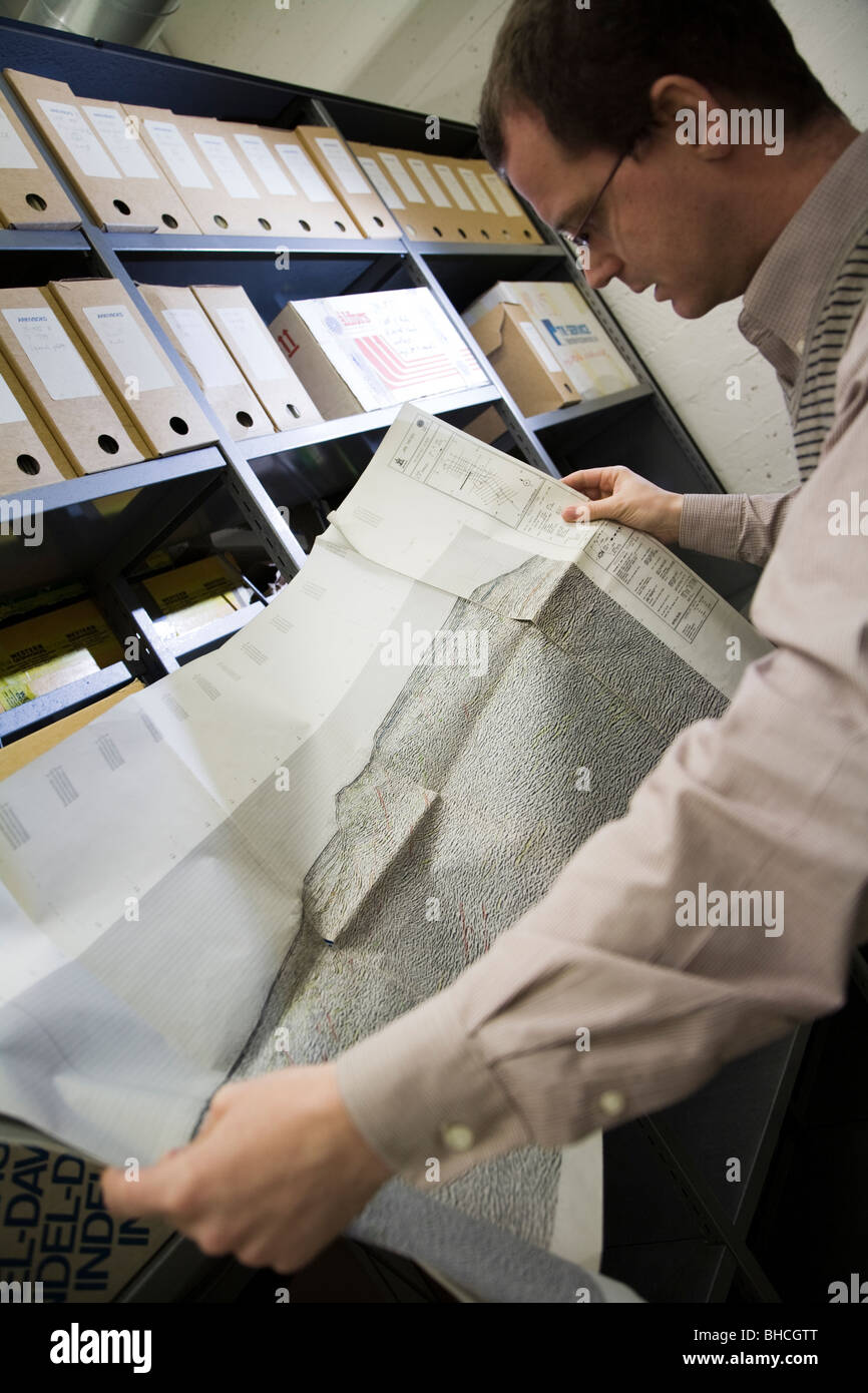 Thorarinn S. Arnarson, Oceanographer and Hydrocarbon Licensing Manager, shows a map with seismic reflection lines... Stock Photo