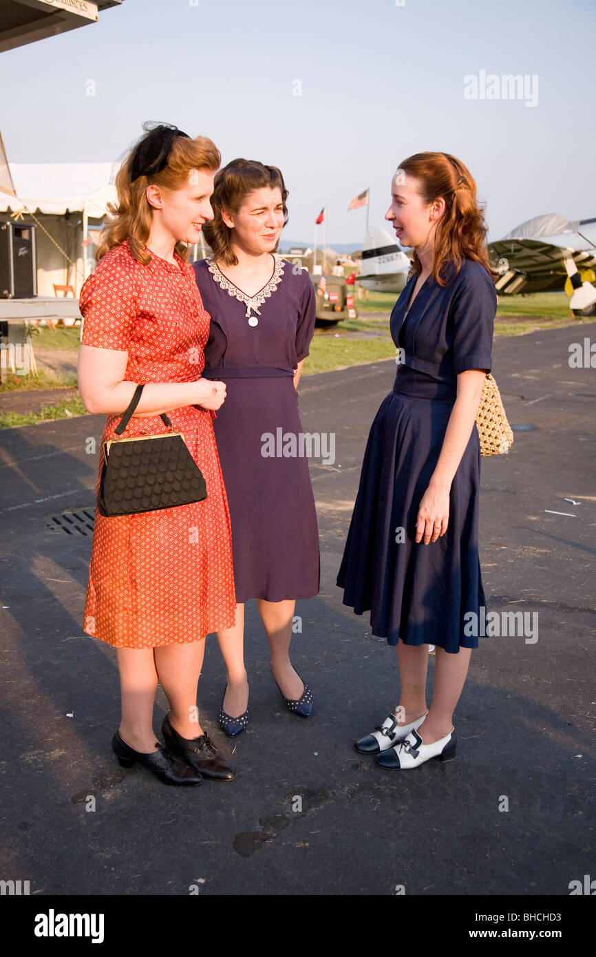 Three women wearing old fashioned 1940s dresses at Mid-Atlantic Air Museum World War II Weekend and Reenactment in Reading, PA Stock Photo