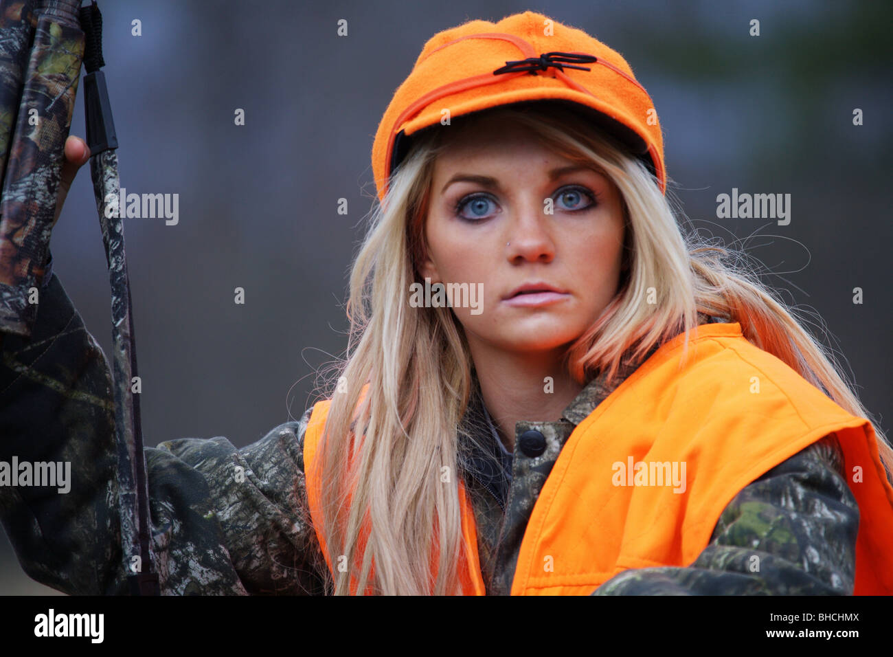 YOUNG WOMAN 21 Y.O. FEMALE HUNTER ORANGE BLAZE VEST STORMY KROMER HAT