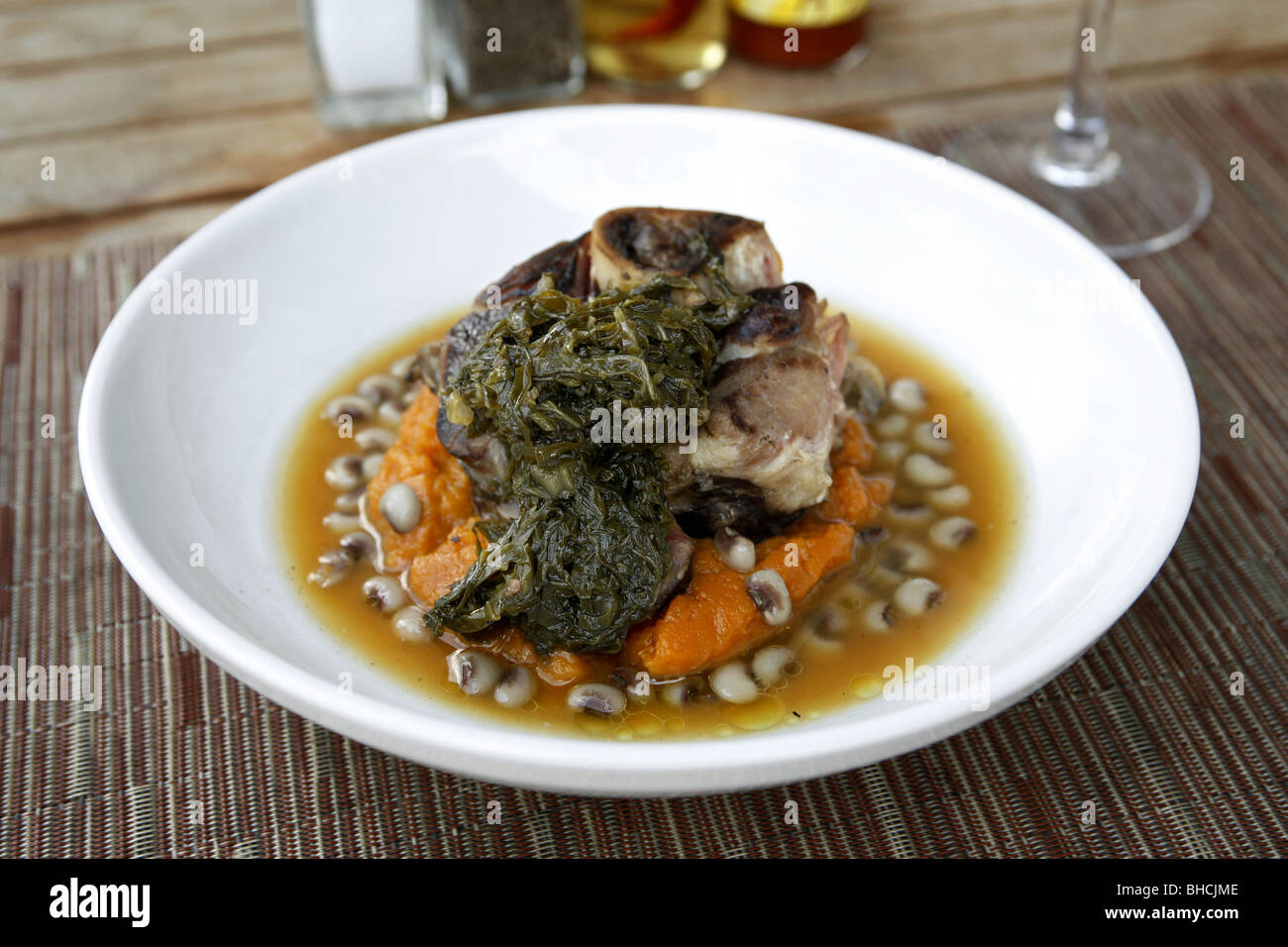 Cajun Cuisine, Ham Hock with Sweet Potatoes, Pickled Greens & Black Eye Pea Ham Broth, Cochon Restaurant, New Orleans, Louisiana Stock Photo