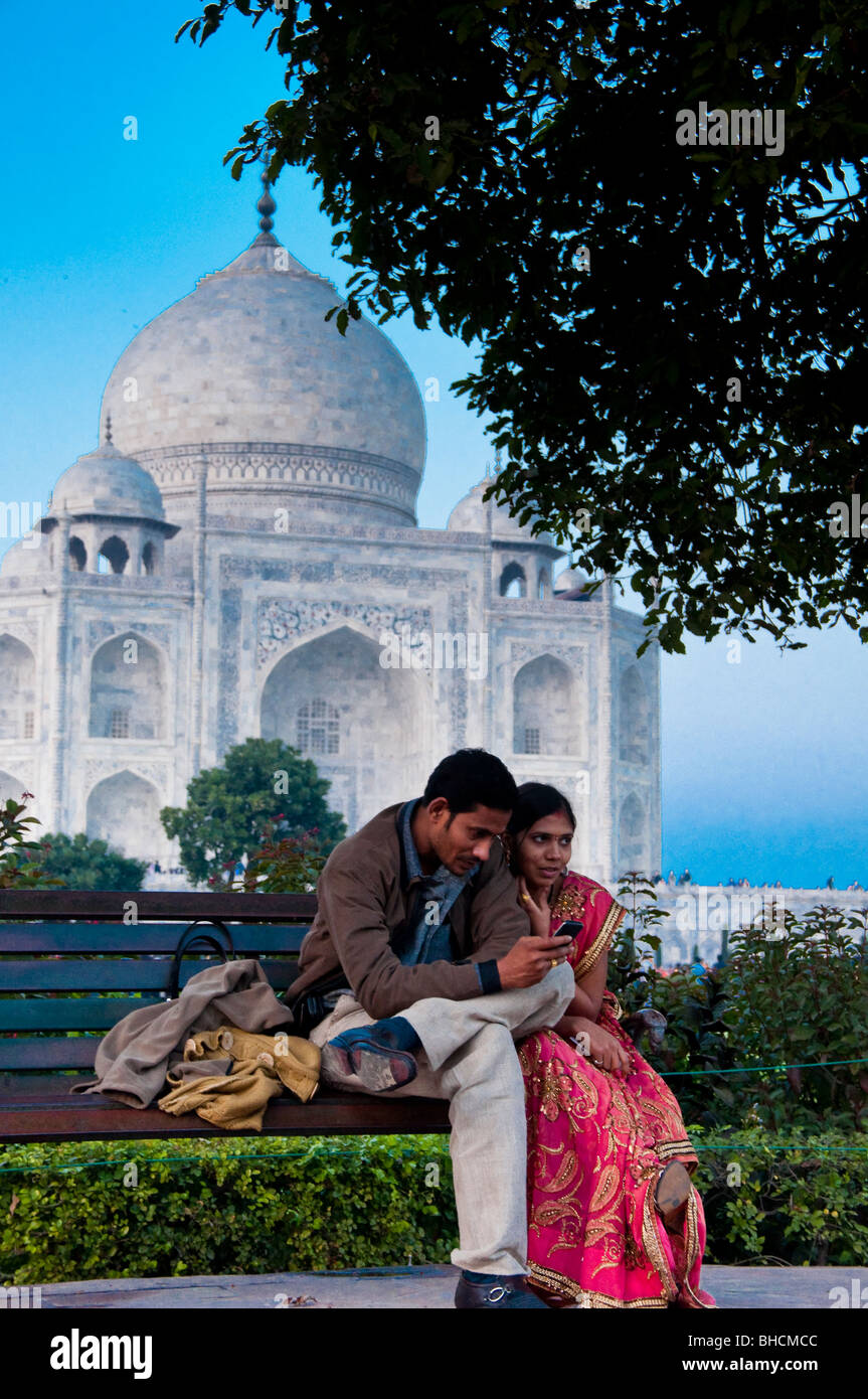 Indian couple sitting on bench in front of Taj Mahal, India Stock Photo