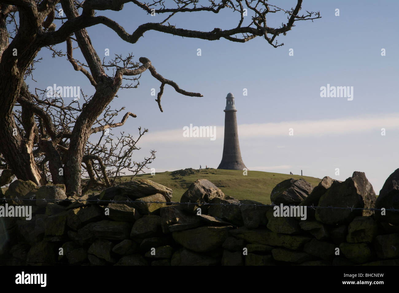 Overlooking the town of Ulverston, England is the dramatic limestone lighthouse facsimile built in honour of Sir John Barrow Stock Photo