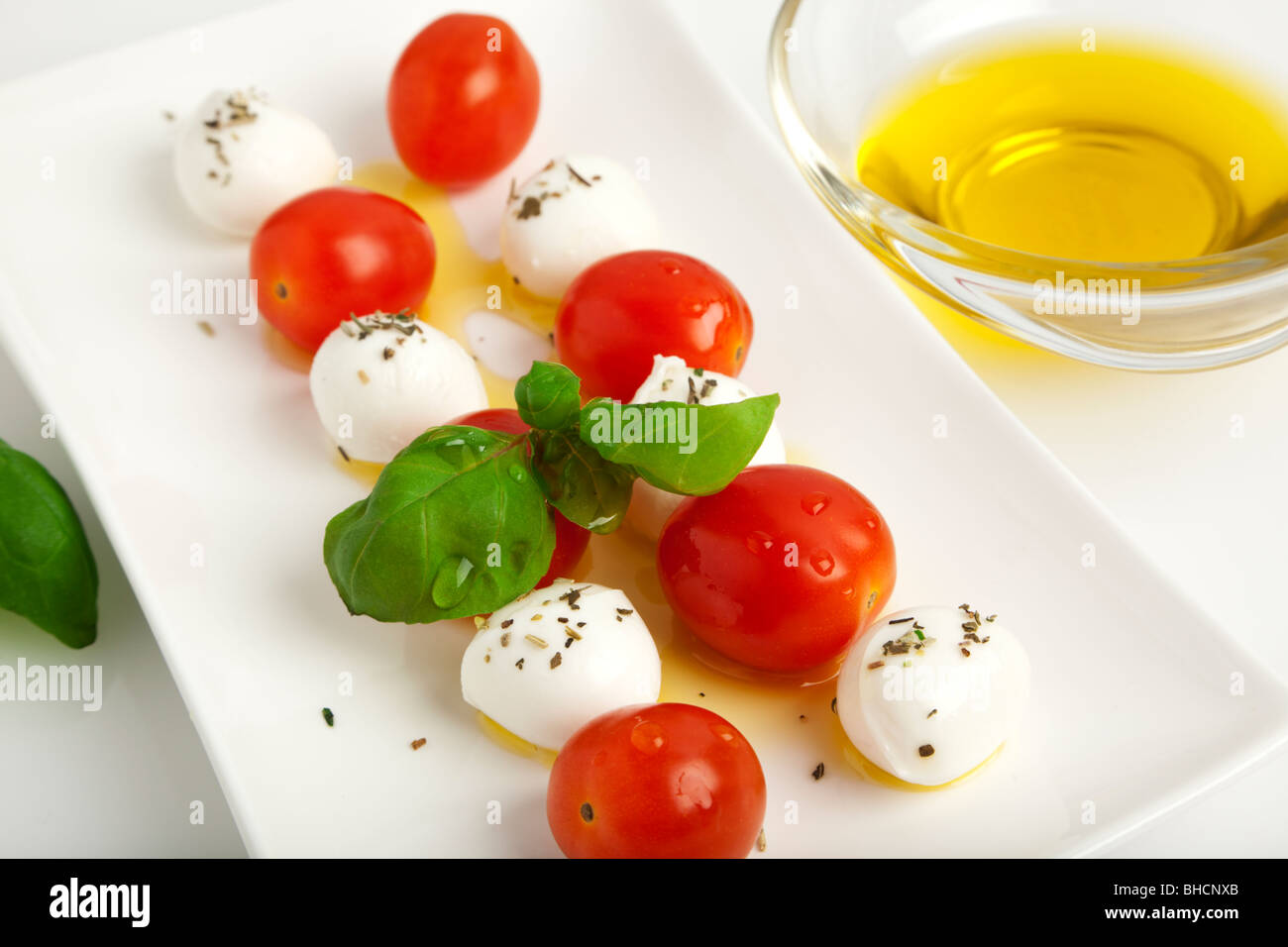mozzarella cheese balls spitted with tomatoes and basil leaves with