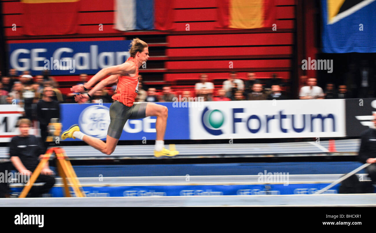 Christian Olsson of Sweden jumps over 17 meters in the triple jump event in the GE Games after several years of injury Stock Photo