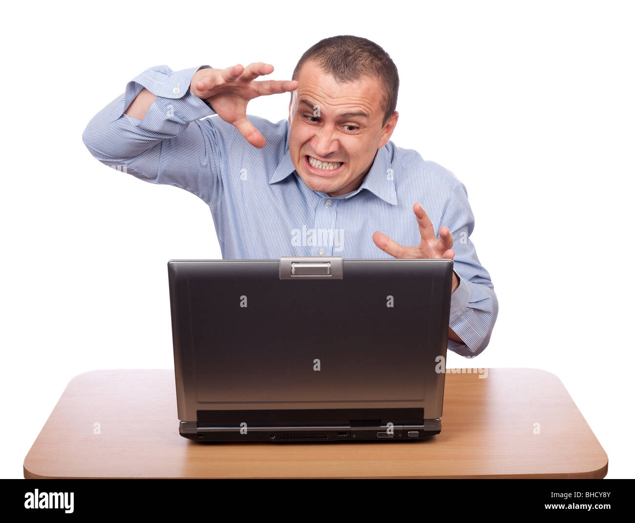 Angry businessman at laptop isolated on white Stock Photo - Alamy