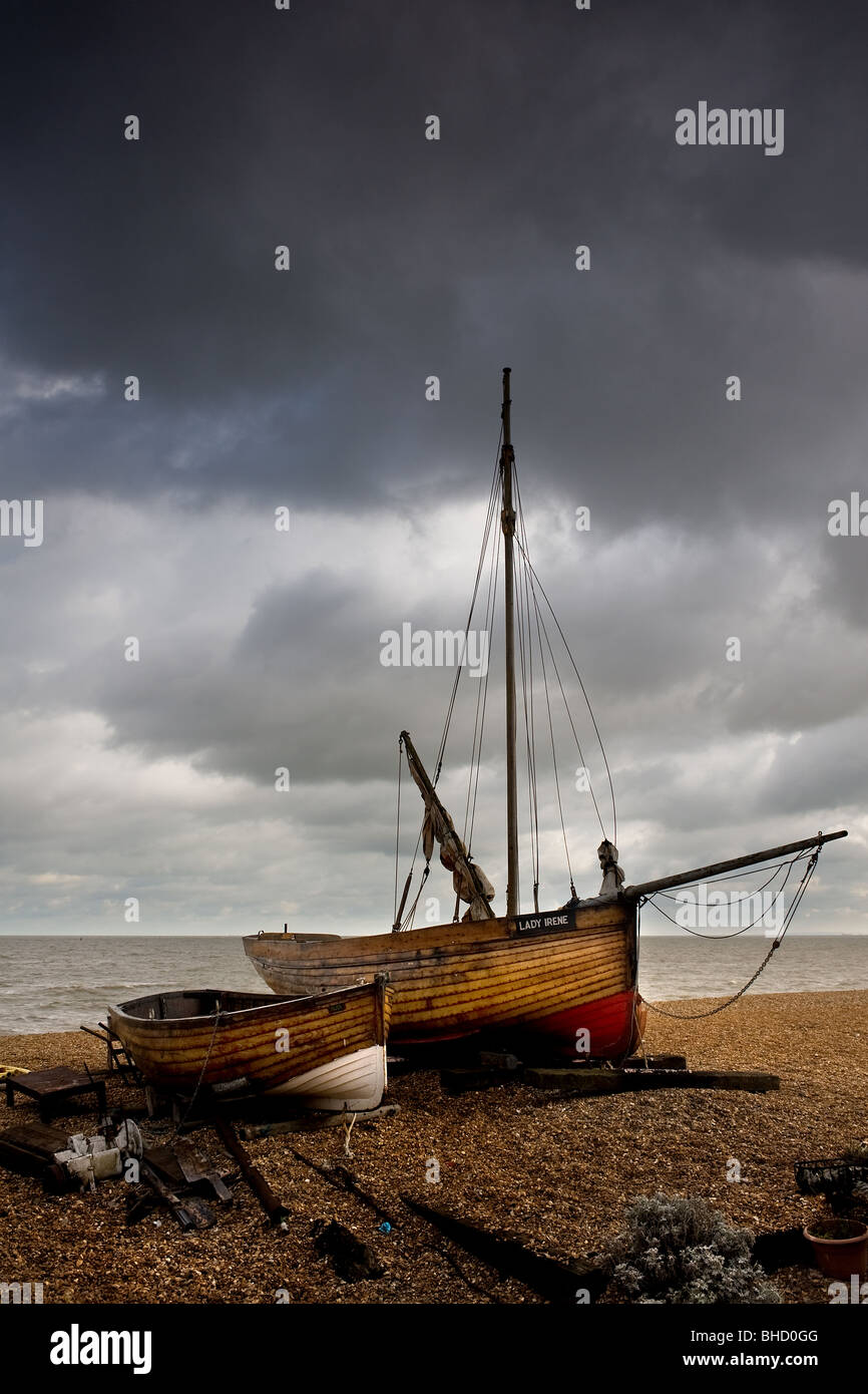 A wooden fishing boat and dinghy beached at Deal in Kent. Photo by