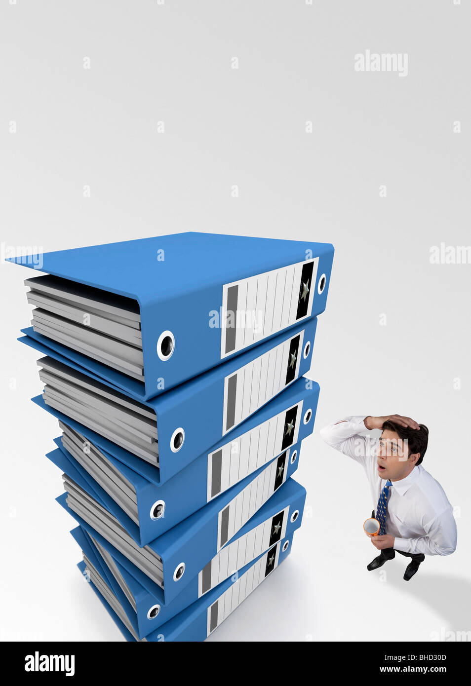 Businessman tensed after looking at a stack of files Stock Photo