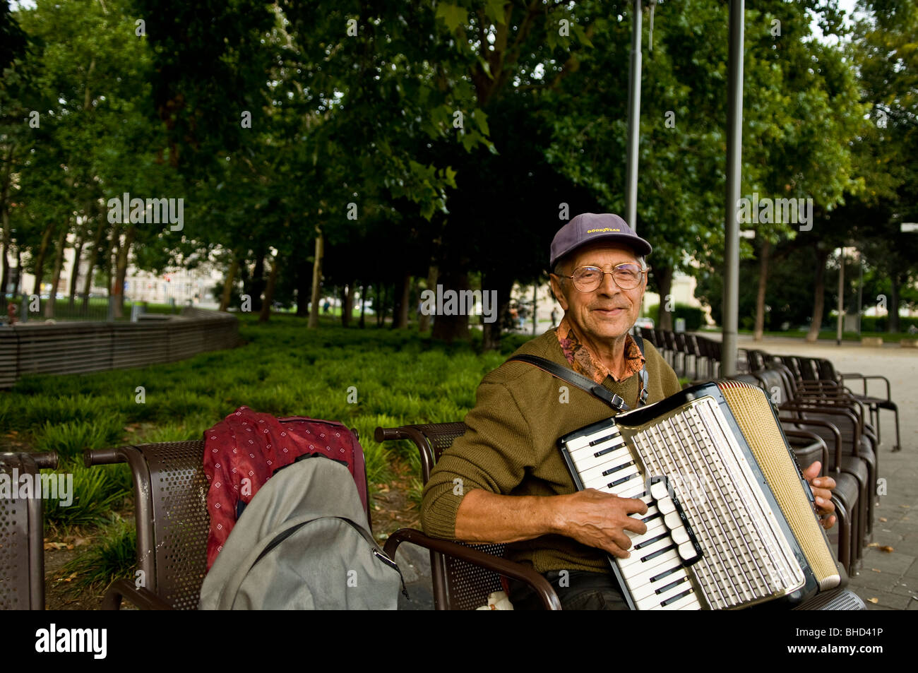 An busking elderly man playing the accordion Stock Photo