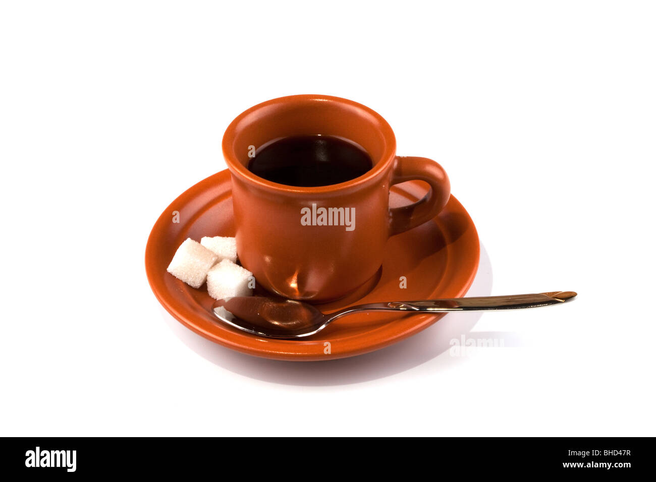 Ceramic cup from coffee, a saucer, a teaspoon, sugar on a white background Stock Photo
