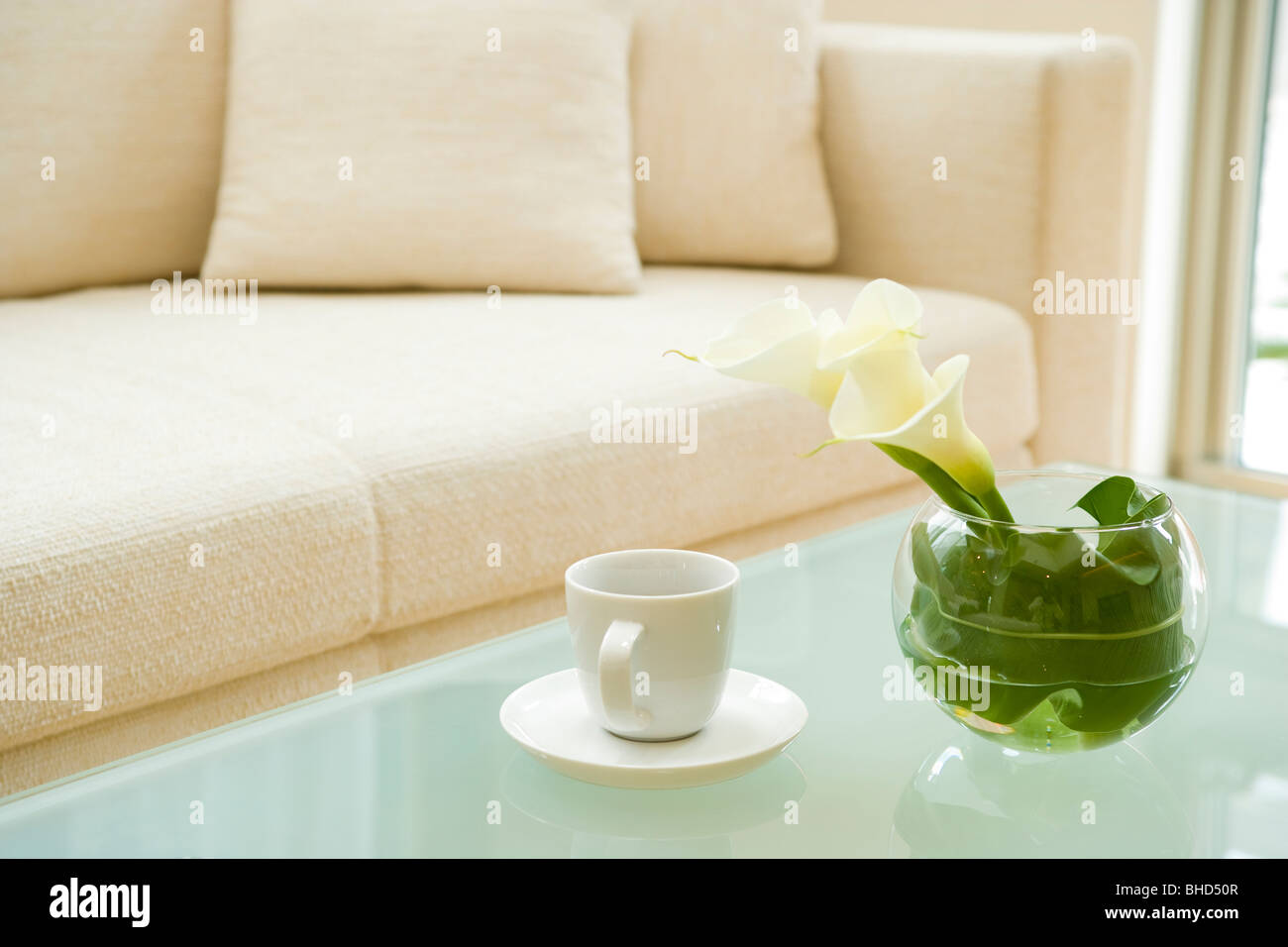 Coffee table with flowers in vase and coffee cup Stock Photo Alamy