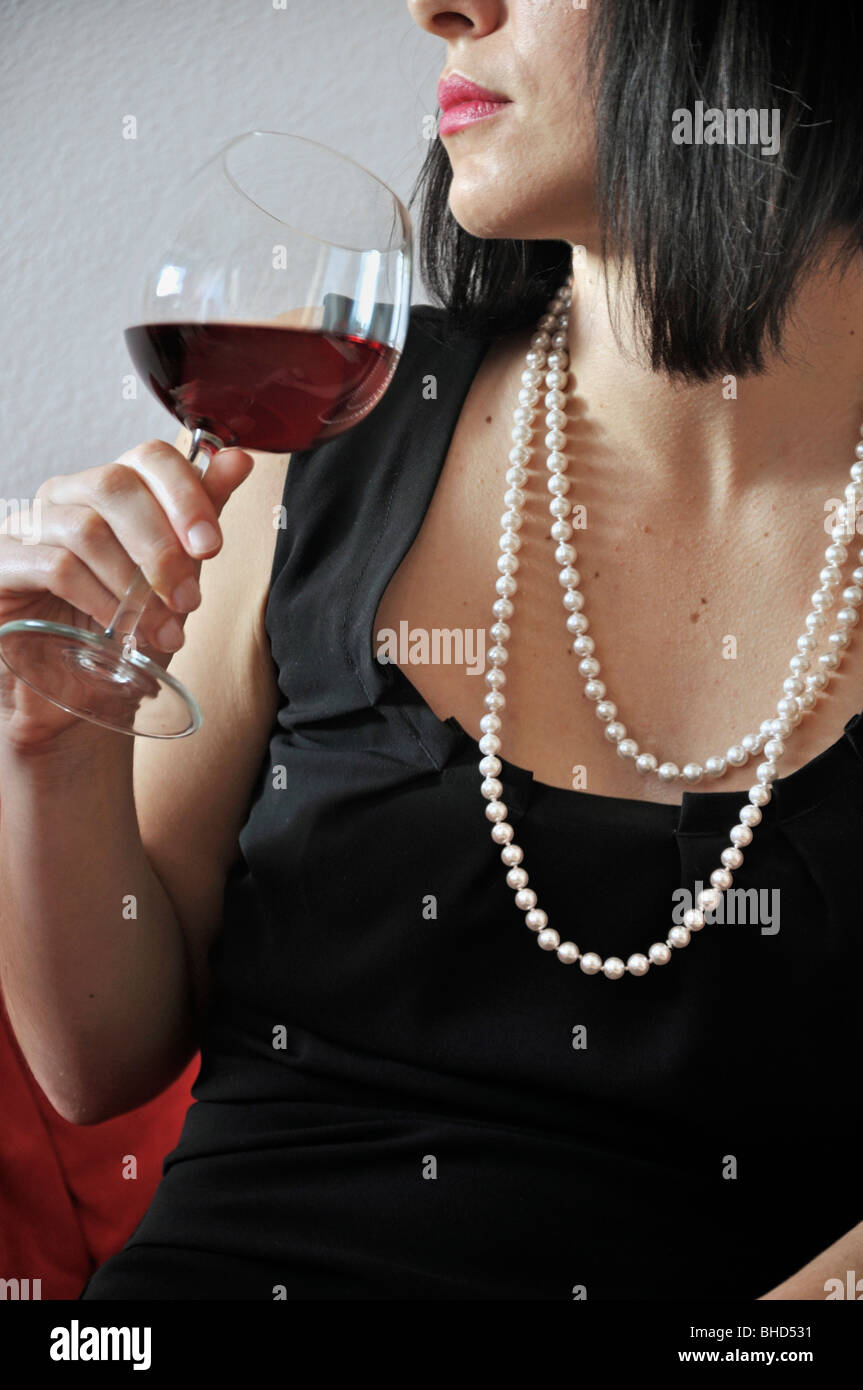 Young woman drinking glass of red wine Stock Photo - Alamy