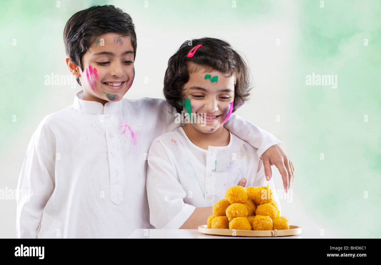 Boy and girl looking at laddoos Stock Photo